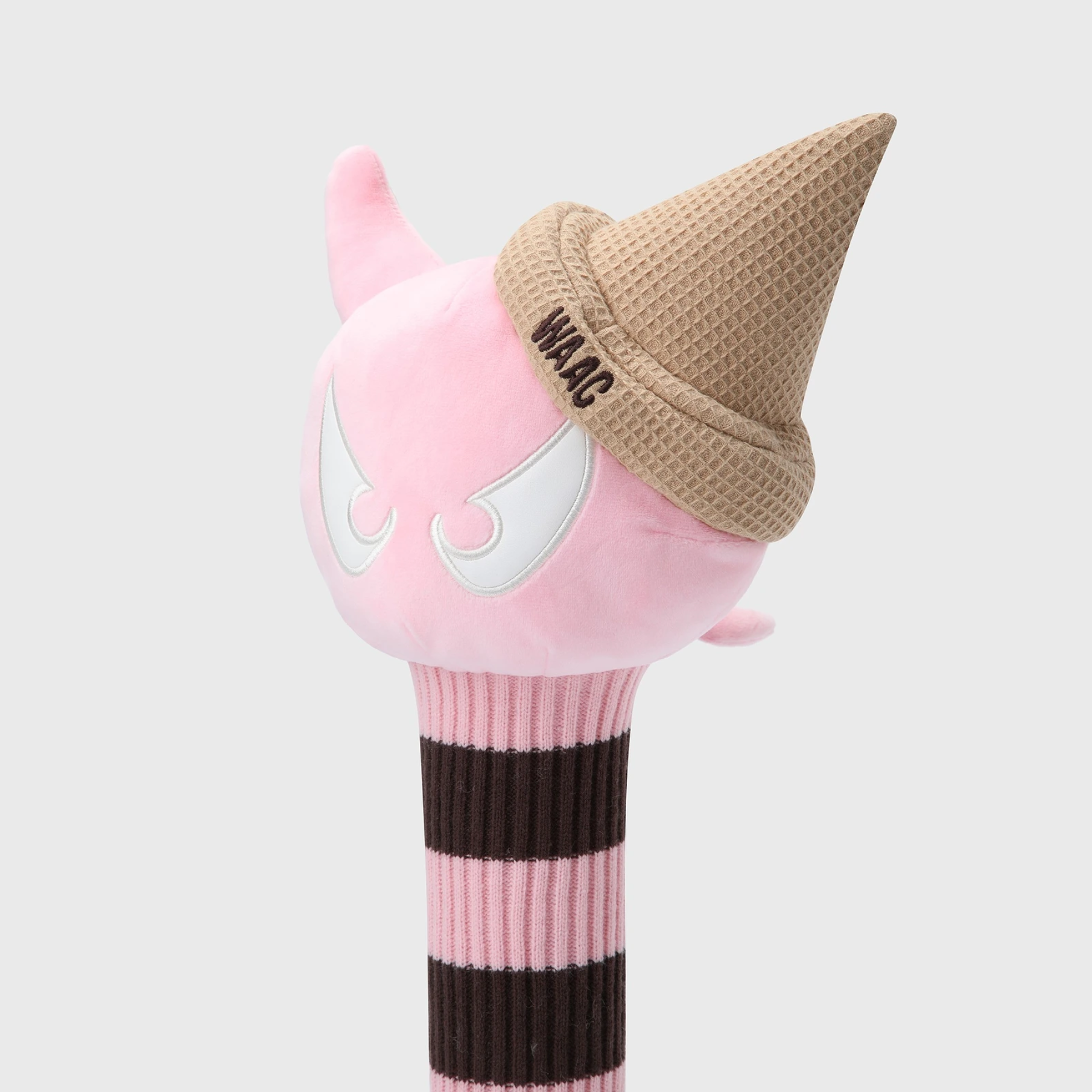 A pink plush golf club headcover shaped like a devil character wearing a waffle-cone hat with 'WAIC' embroidered on it, set against a light gray background.