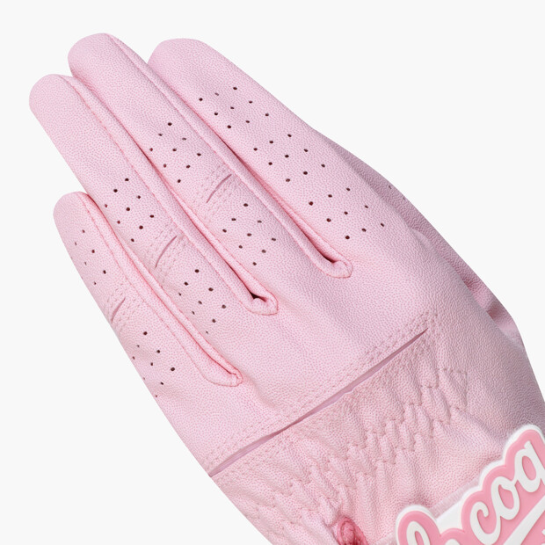 A single light pink leather golf glove with perforated finger panels and a stitched wrist cuff, shown on a plain light gray background.
