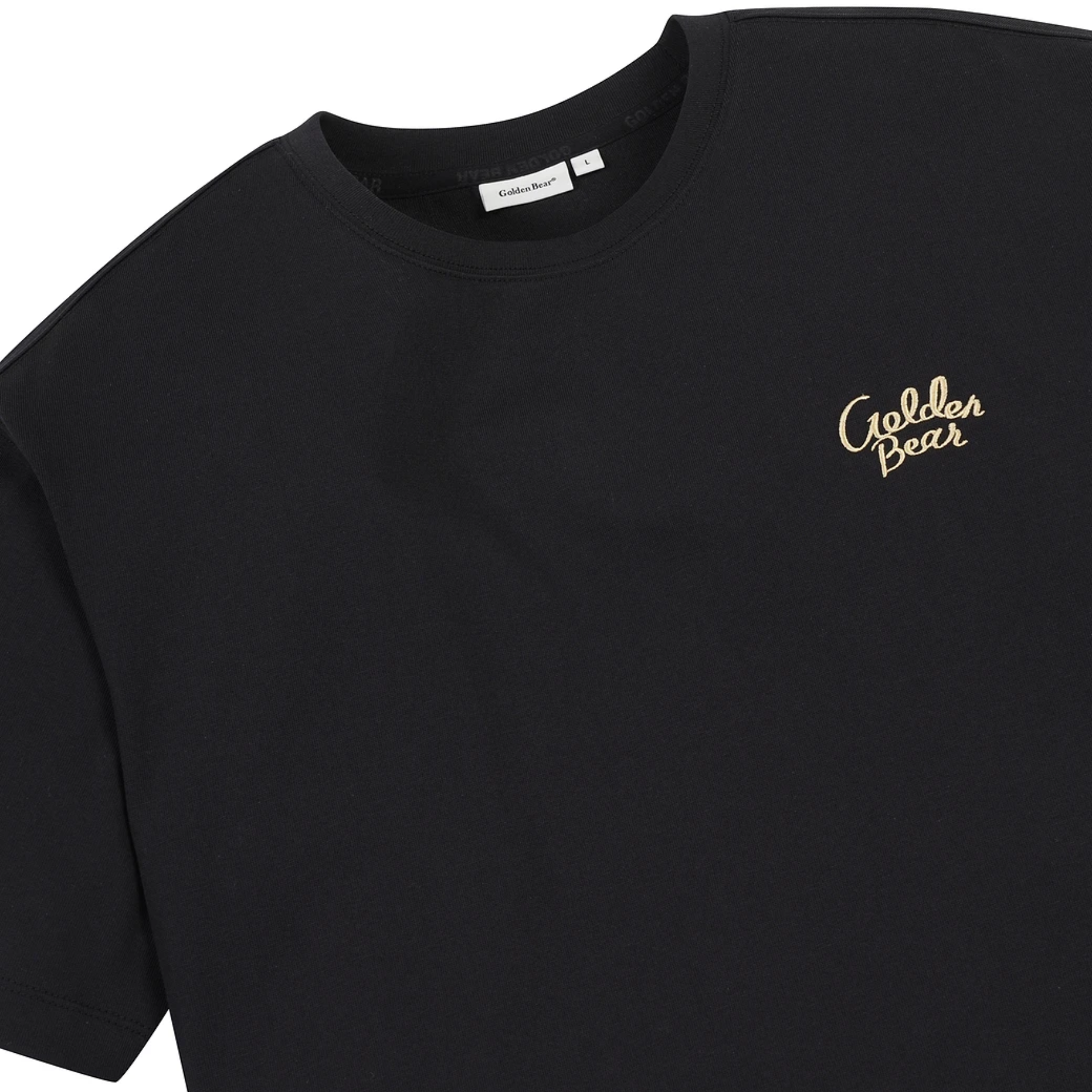 A close-up of a black short-sleeve crewneck t-shirt featuring the brand name 'Golden Bear' embroidered in gold cursive script on the left chest.