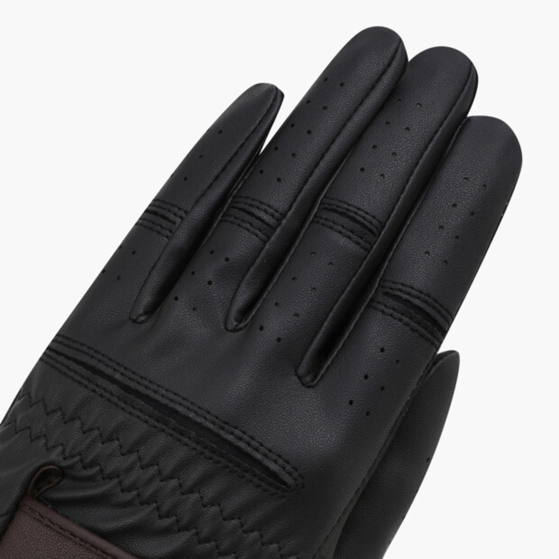 Close-up of a black leather glove showing the back of the hand with perforated fingertips, stitched seams, and a textured cuff on a light gray background.