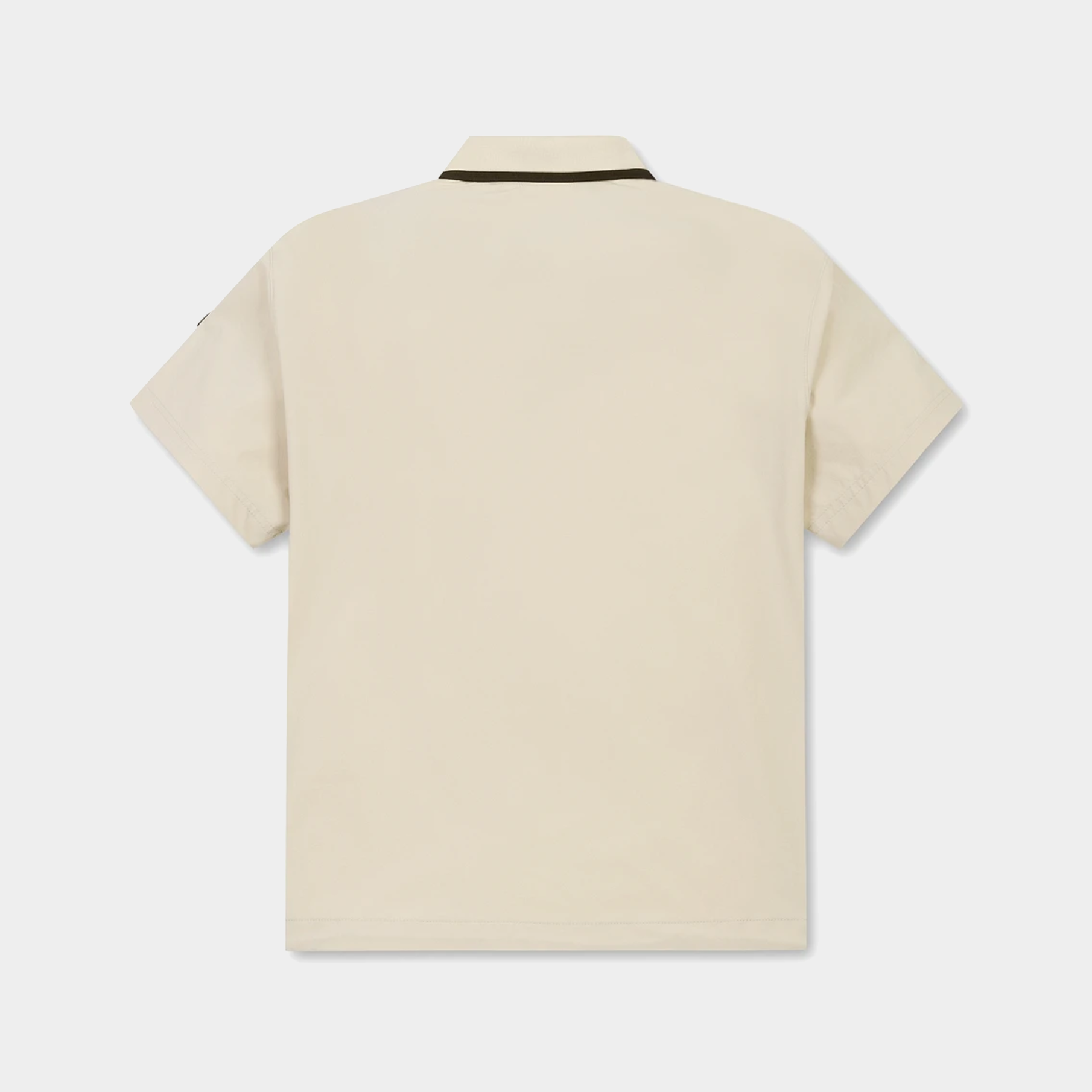 A short-sleeve polo shirt shown from the back, in a light cream or off-white color with a thin dark brown stripe detail at the collar, displayed on a clean light gray background.