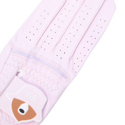 A light pink golf glove with a decorative patch on the cuff featuring a fox face and the letters 'GB', shown on a plain white background.