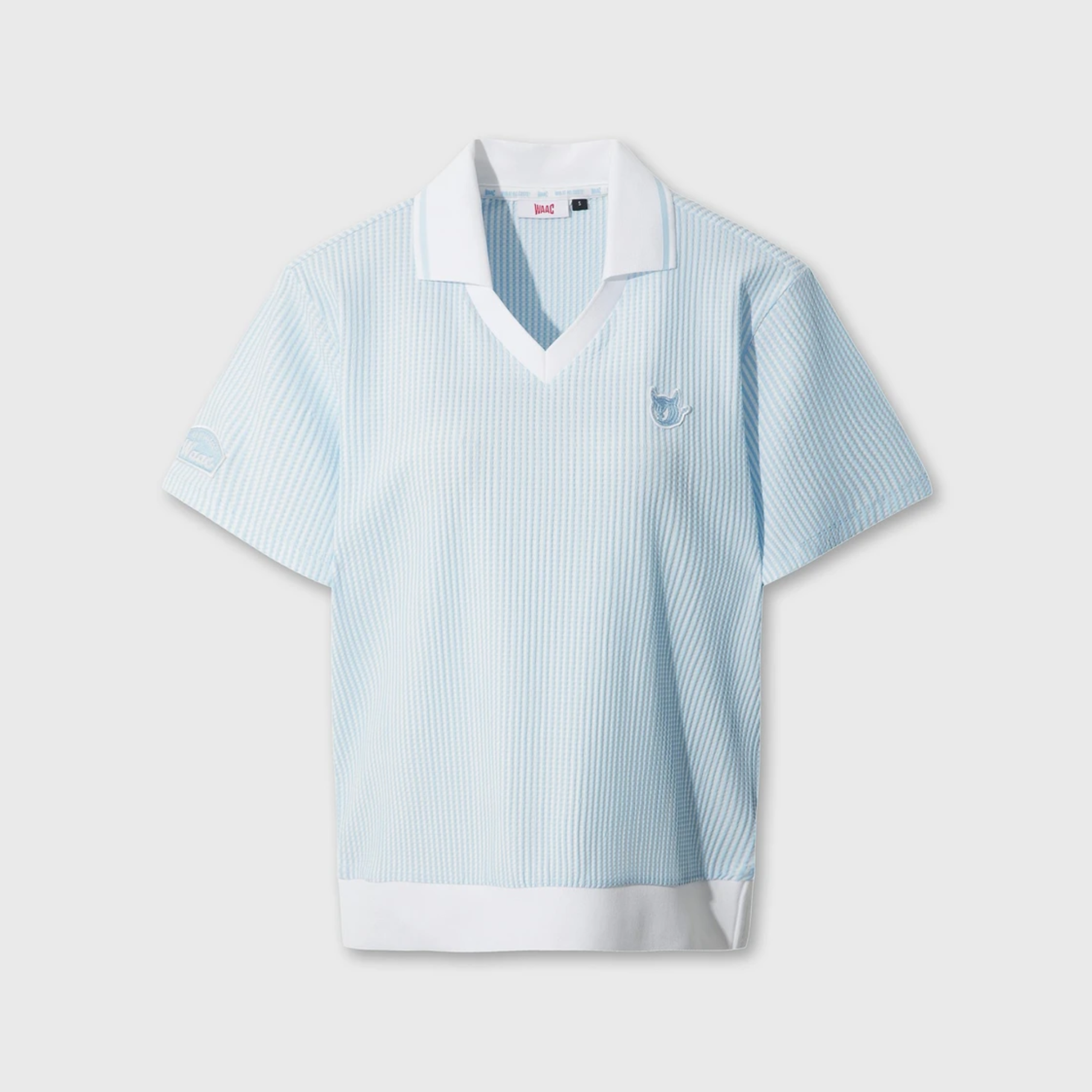 Women's light blue seersucker golf polo with white collar and V-neck ribbed trim.