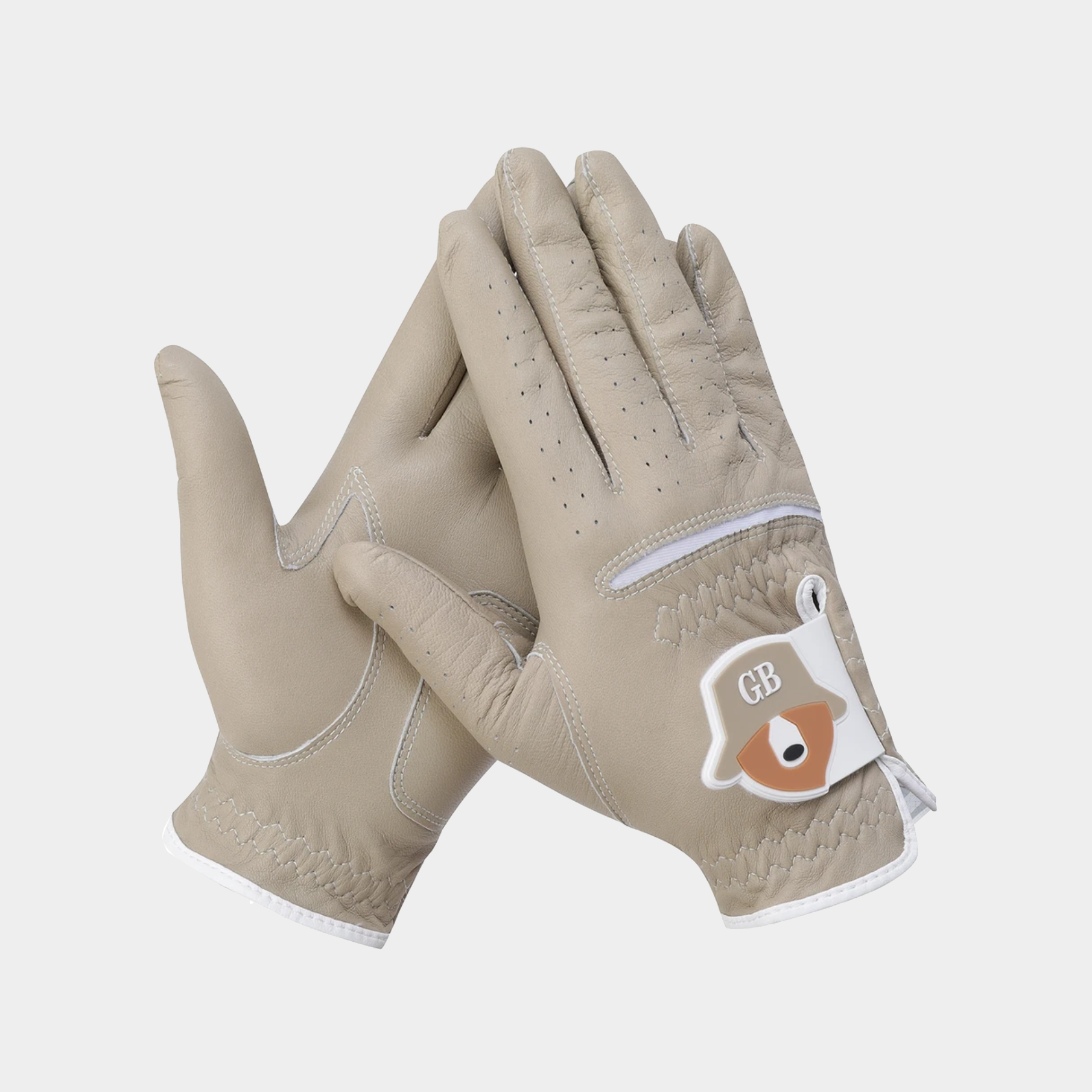 A pair of light beige leather golf gloves with white trim and a white wrist patch featuring a brown raccoon and the letters 'GB'.