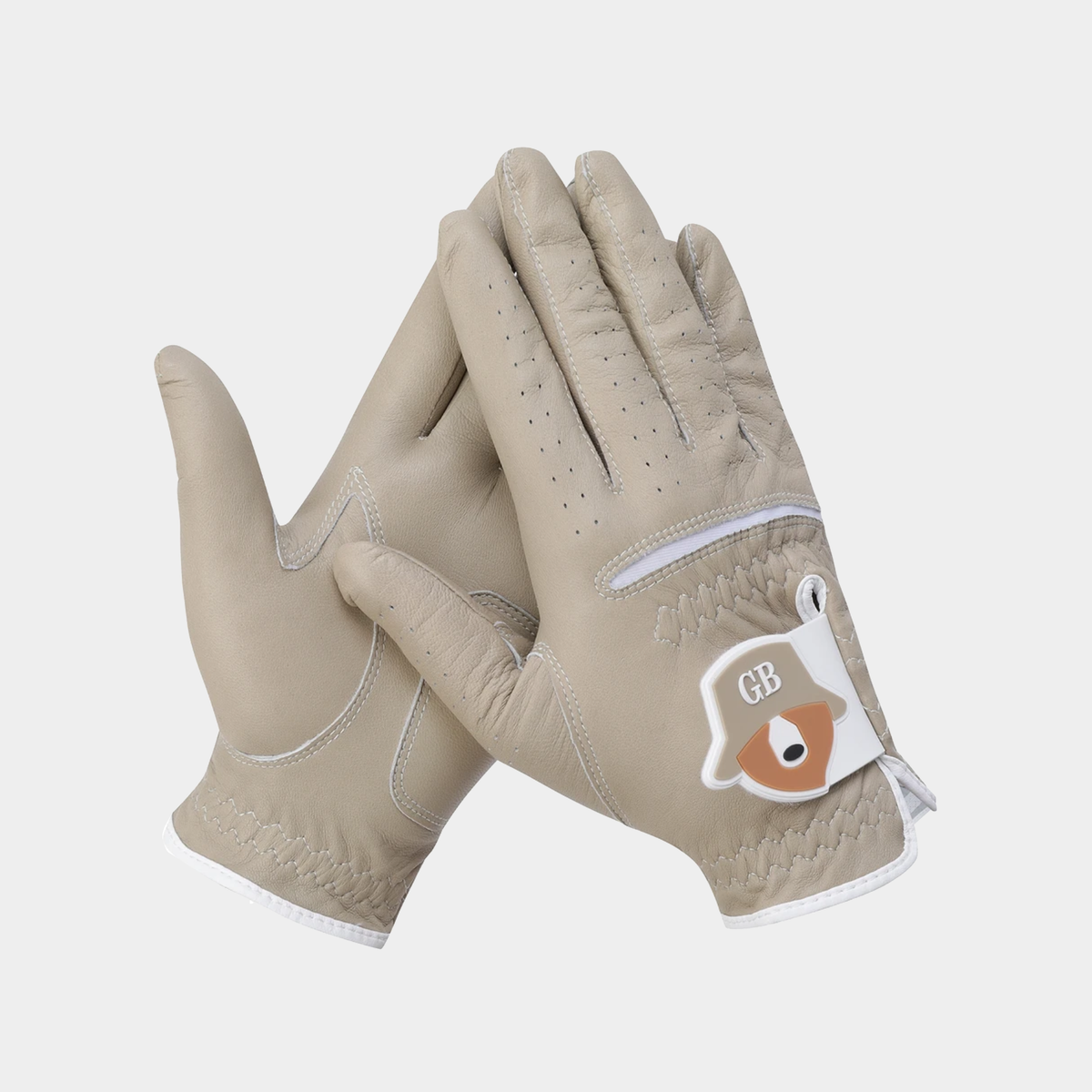 A pair of light beige leather golf gloves with white trim and a white wrist patch featuring a brown raccoon and the letters 'GB'.