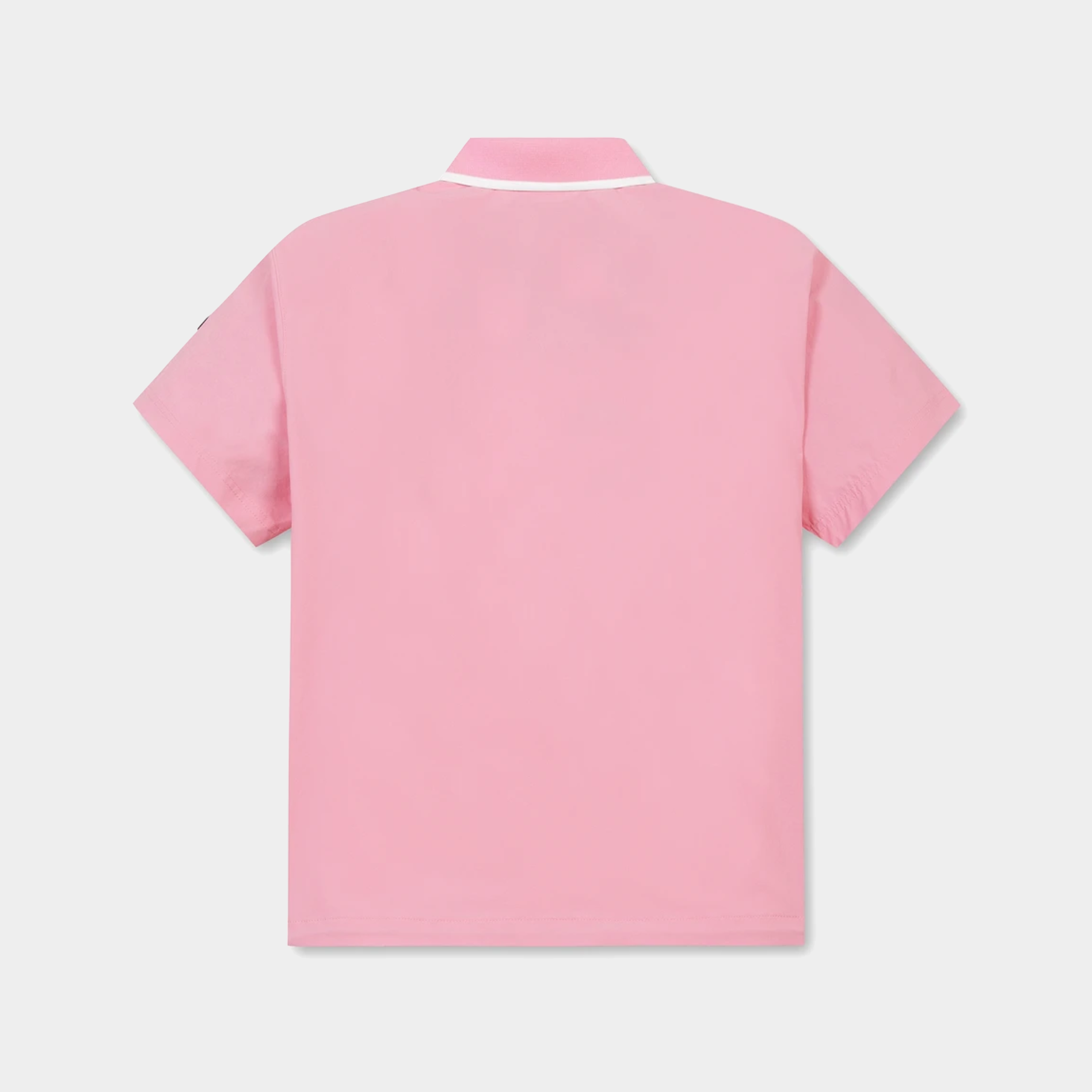 A light pink short-sleeve polo shirt shown from the back, featuring a white contrast collar trim, set against a light gray background.