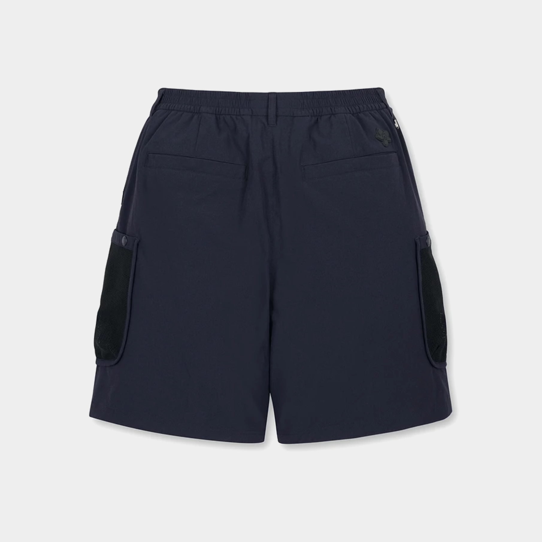 A pair of dark navy blue shorts with black contrast panels on the side pockets, shown from the back against a light gray background.