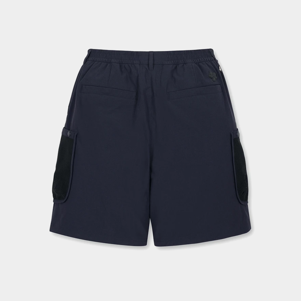 A pair of dark navy blue shorts with black contrast panels on the side pockets, shown from the back against a light gray background.