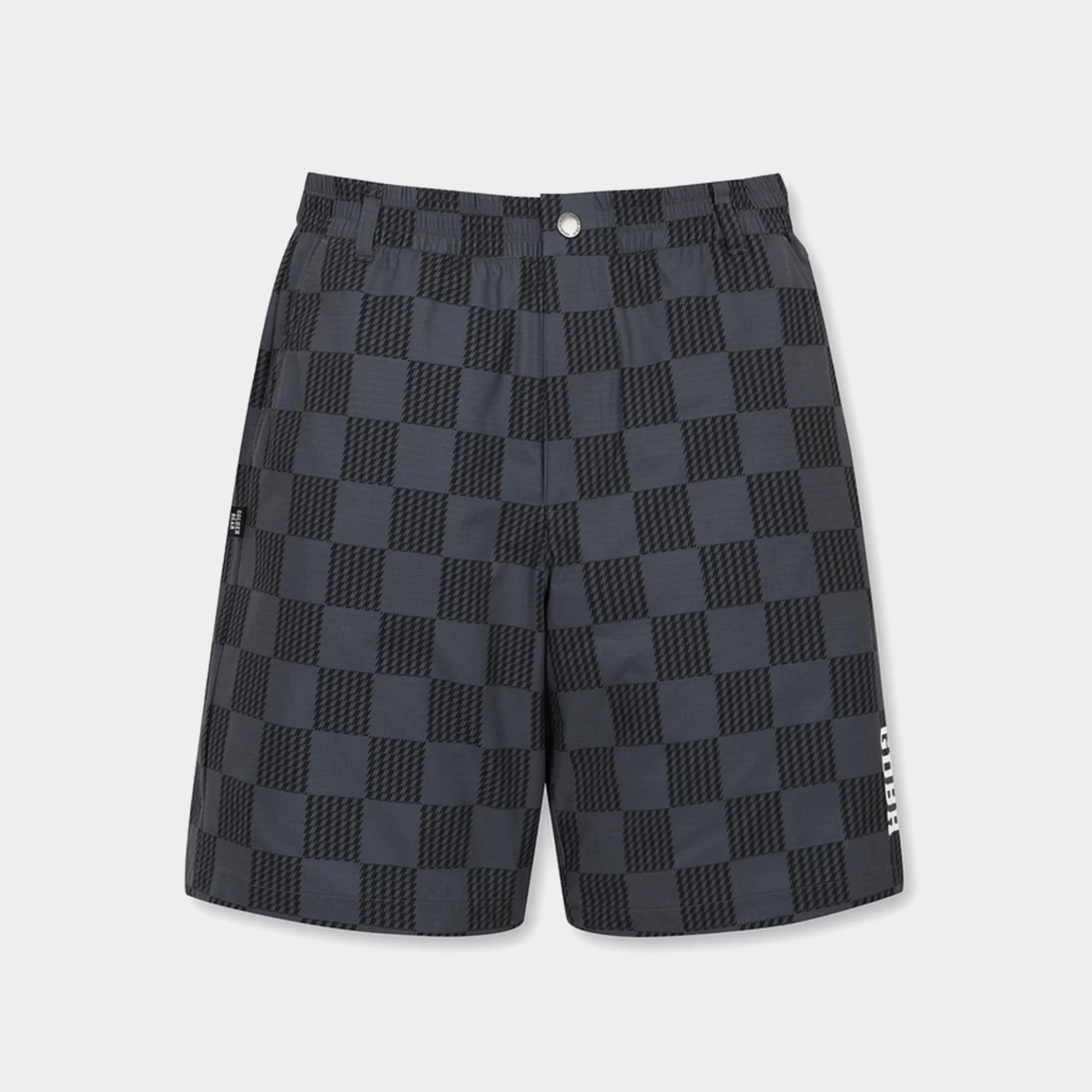 A pair of dark gray and black checkerboard patterned shorts with a white vertical logo on the lower left leg, displayed against a light gray background.