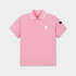 A pink short-sleeve polo shirt with a white contrast collar, featuring a small white geometric logo on the left chest and a black brand patch on the right sleeve, displayed on a light gray background.