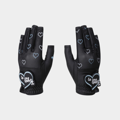 A pair of black fingerless cycling gloves with a pattern of light blue outlined hearts and a white heart patch on the back of the hand that reads 'le coq sportif'.
