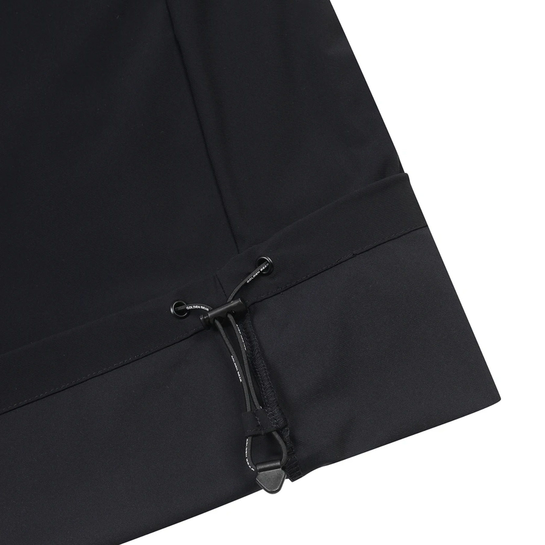 Close-up of a black garment sleeve or cuff with a drawstring toggle and elastic band, shown on a white background.