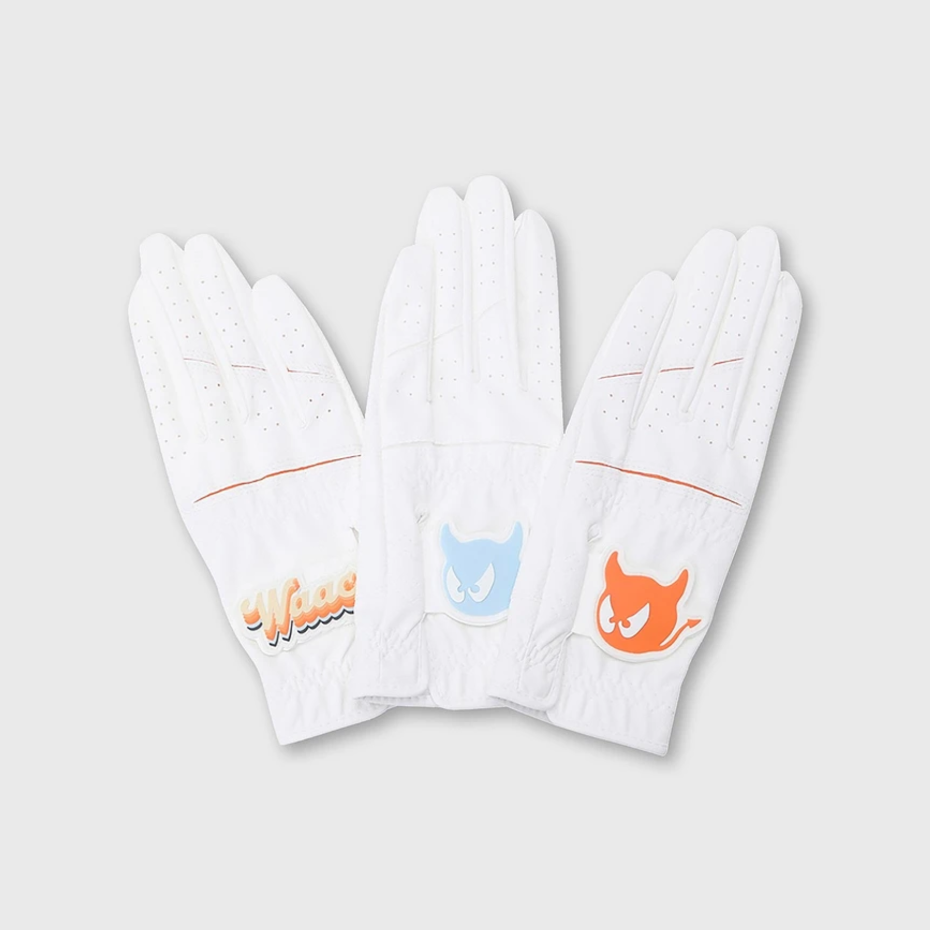Three white golf gloves arranged side by side on a light gray background, each featuring a different colorful graphic logo on the back of the hand.