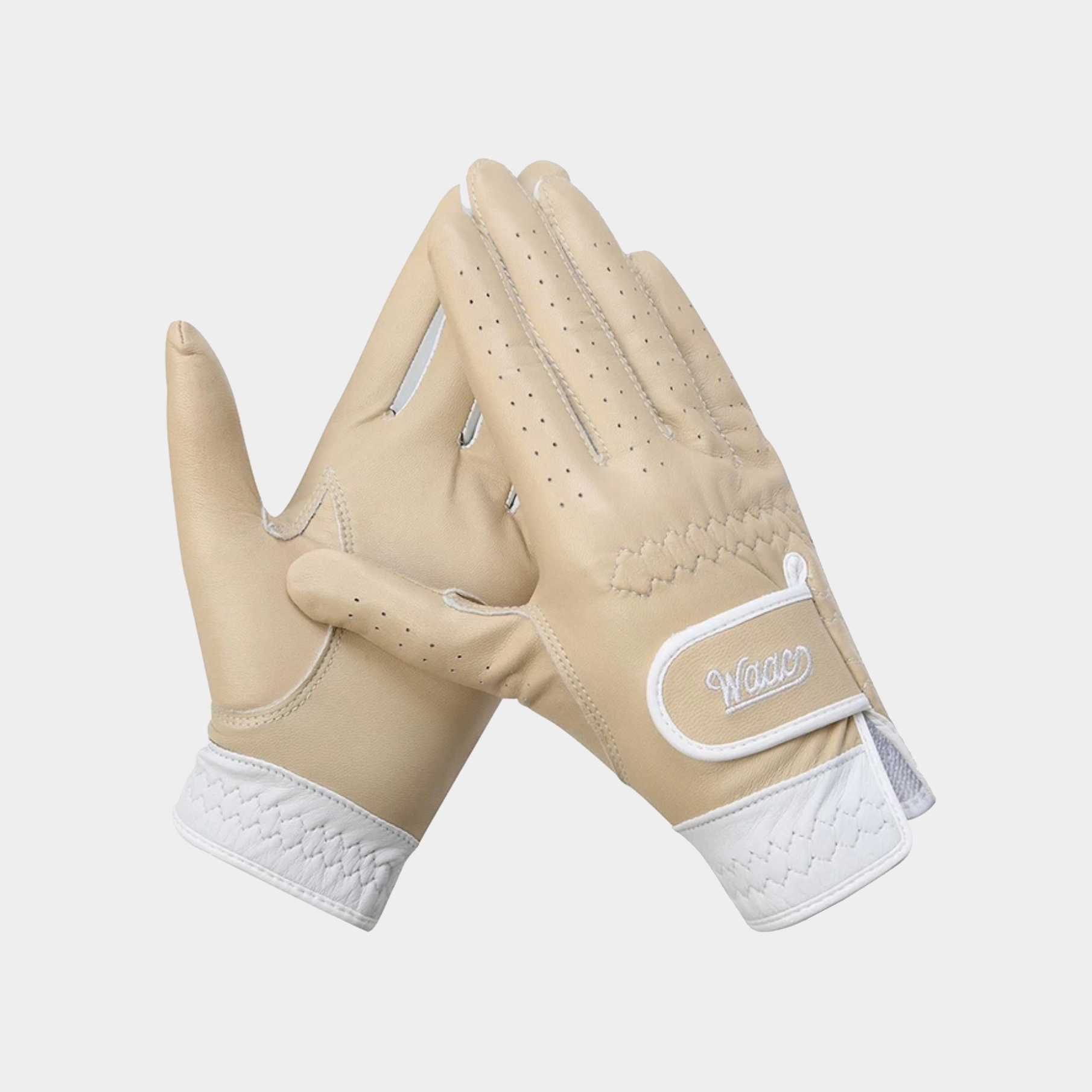 A pair of beige leather golf gloves with white trim and a white logo patch, displayed against a light gray background.