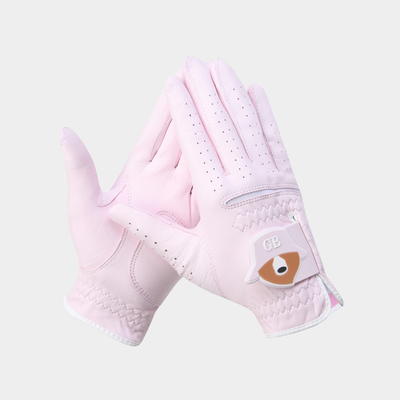 A pair of light pink golf gloves with white trim and a small brown and white patch on the back of the hand, displayed against a light gray background.