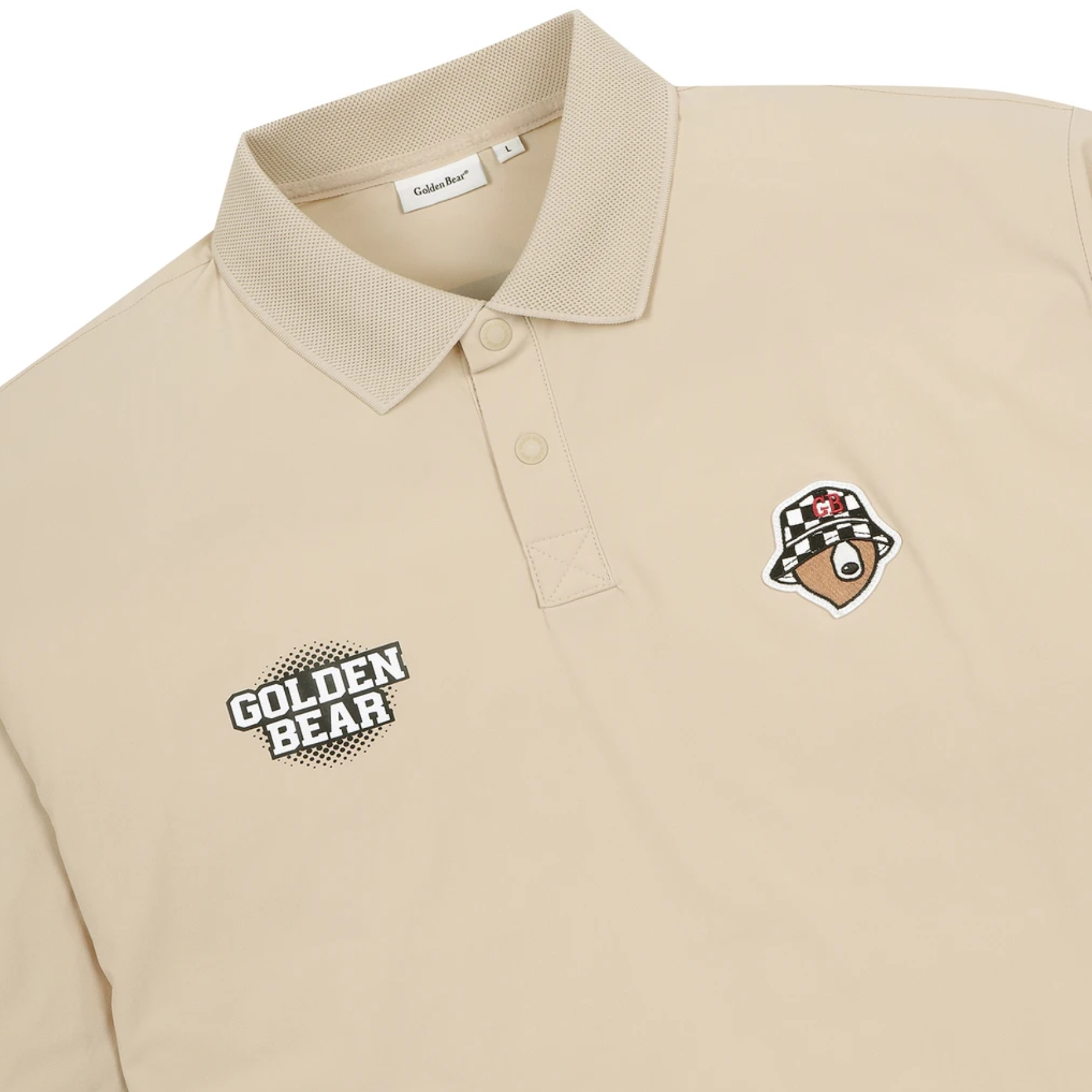 A beige polo shirt by Golden Bear, featuring a black and white 'GOLDEN BEAR' logo patch on the left chest and a brown bear head patch wearing a checkered hat on the right chest. The collar is ribbed, and the buttons are light beige.