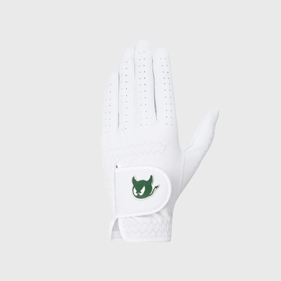 A white golf glove with a green devil logo patch on the wrist strap, shown against a light gray background.