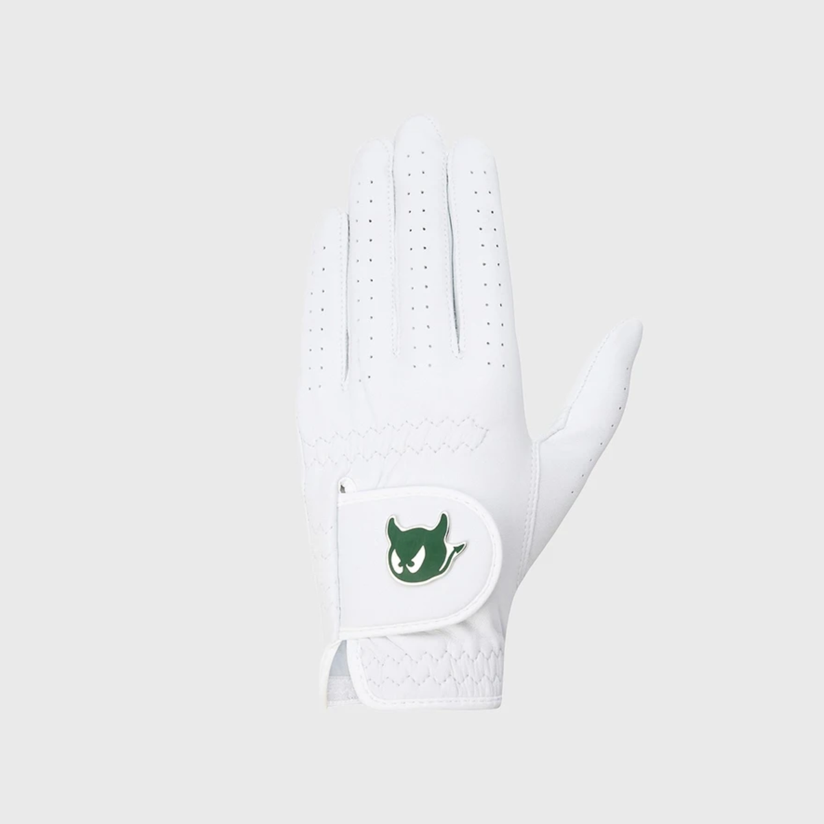 A white golf glove with a green devil logo patch on the wrist strap, shown against a light gray background.