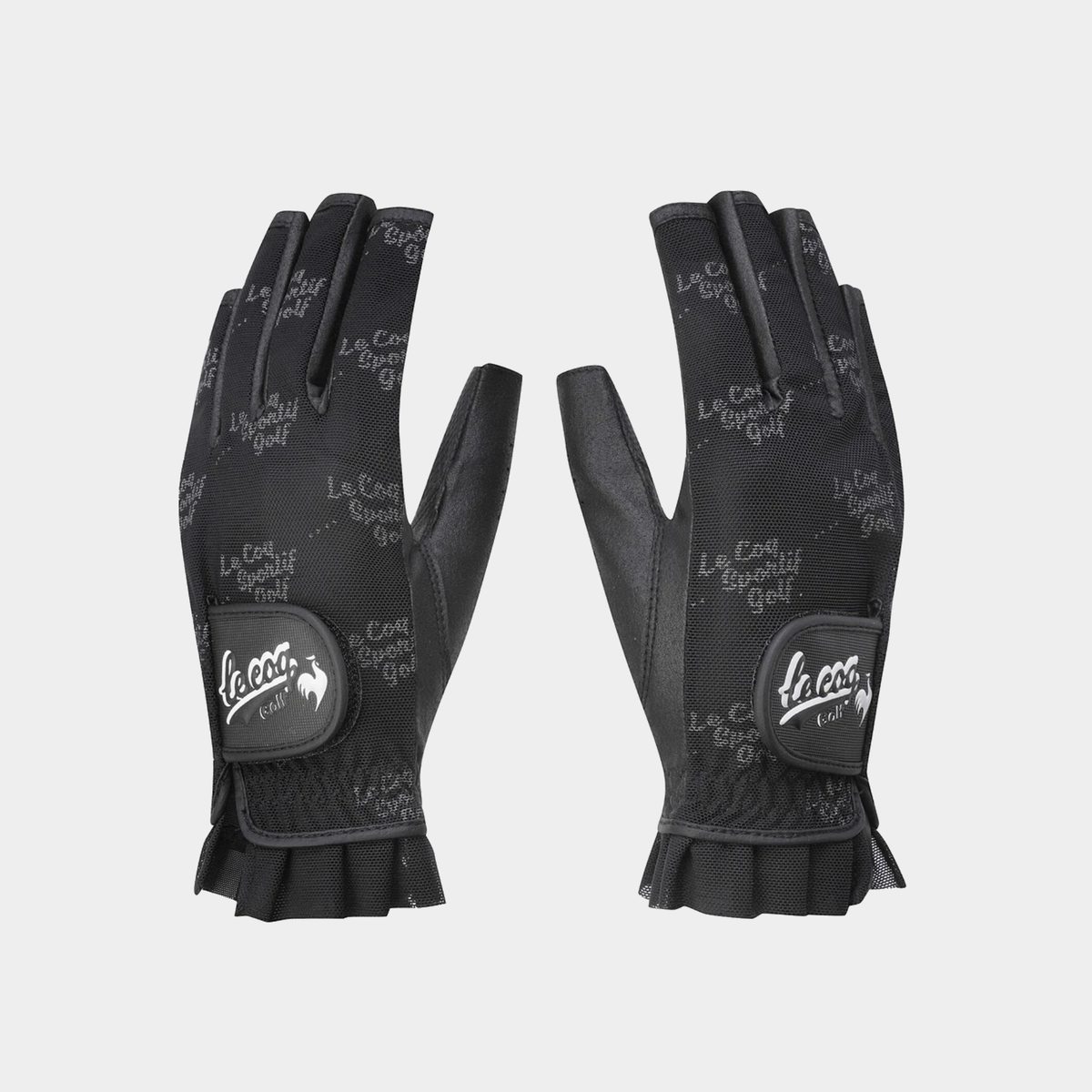 A pair of black Le Coq Golf fingerless gloves with a textured patterned back and a black leather wrist patch featuring the white Le Coq logo.