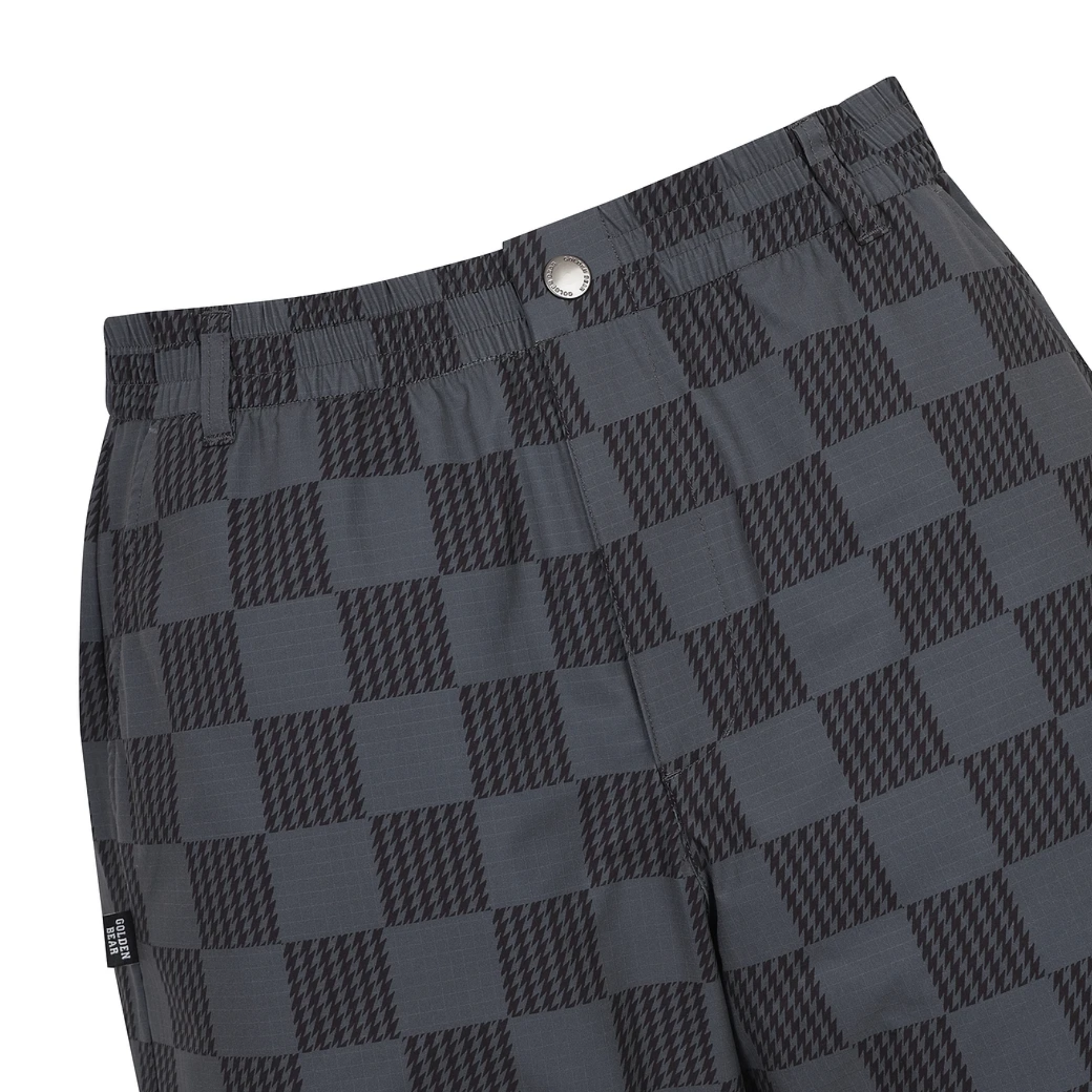 Close-up of dark gray and black checkered patterned shorts with an elastic waistband and a silver button closure, shown on a plain white background.