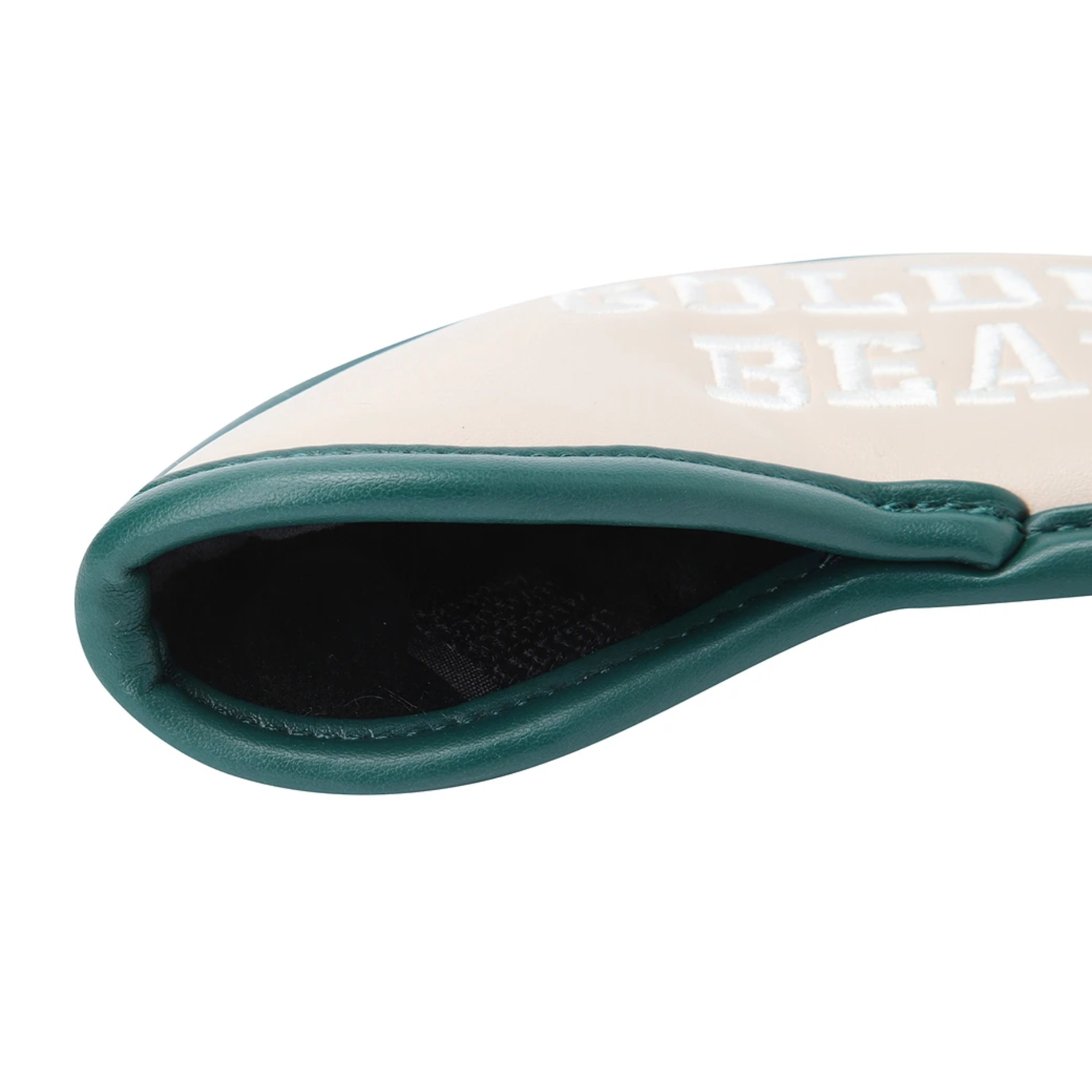 Close-up of a golf club headcover with a cream-colored face, dark green leather trim, and white 'GOLDEN BEAR' branding, shown on a white background.