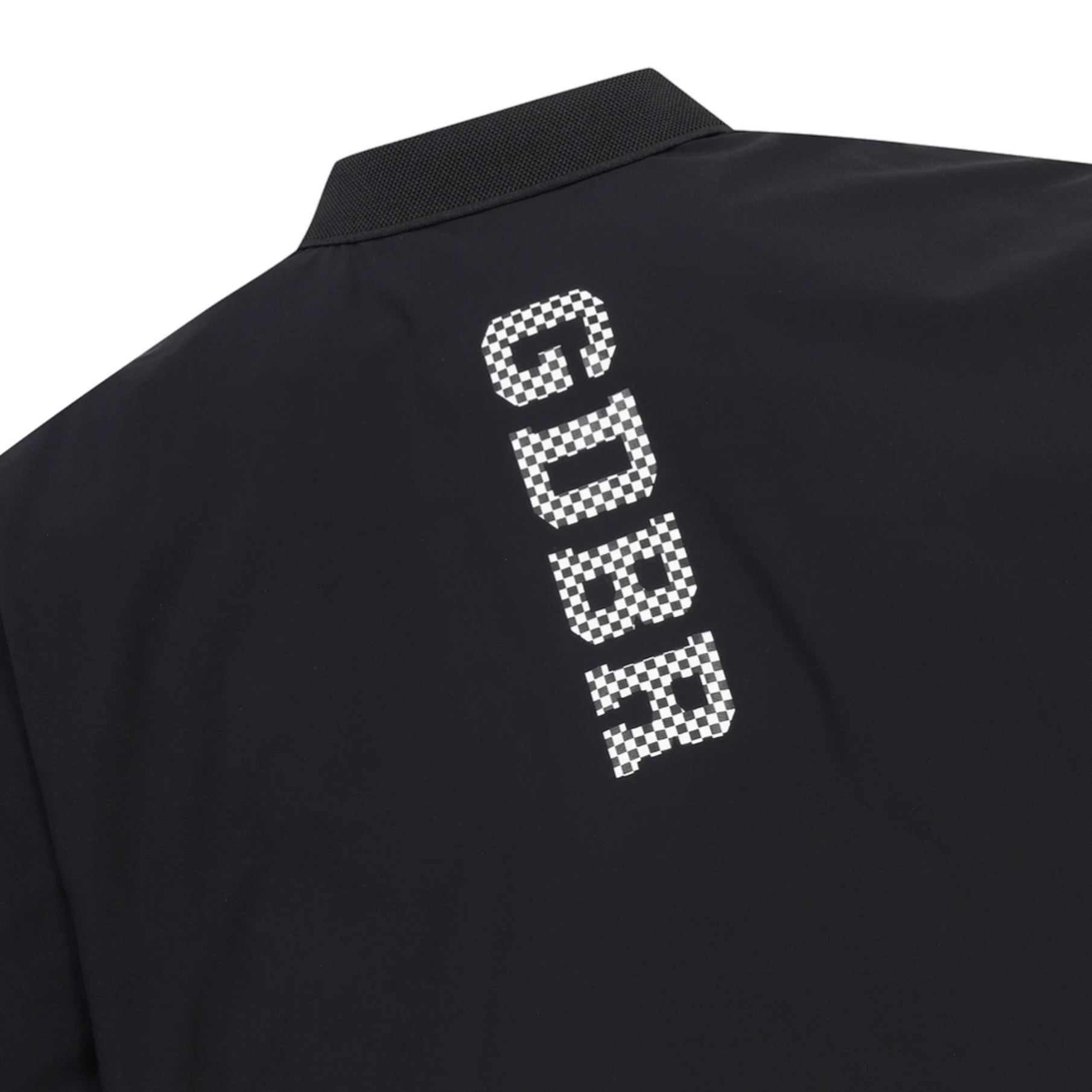 Close-up of the back of a black collared shirt with a large vertical white checkerboard-textured 'GDBR' logo printed on the upper back.