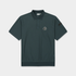 A dark green short-sleeve polo shirt with a small white and black graphic logo on the left chest, displayed flat against a light gray background.