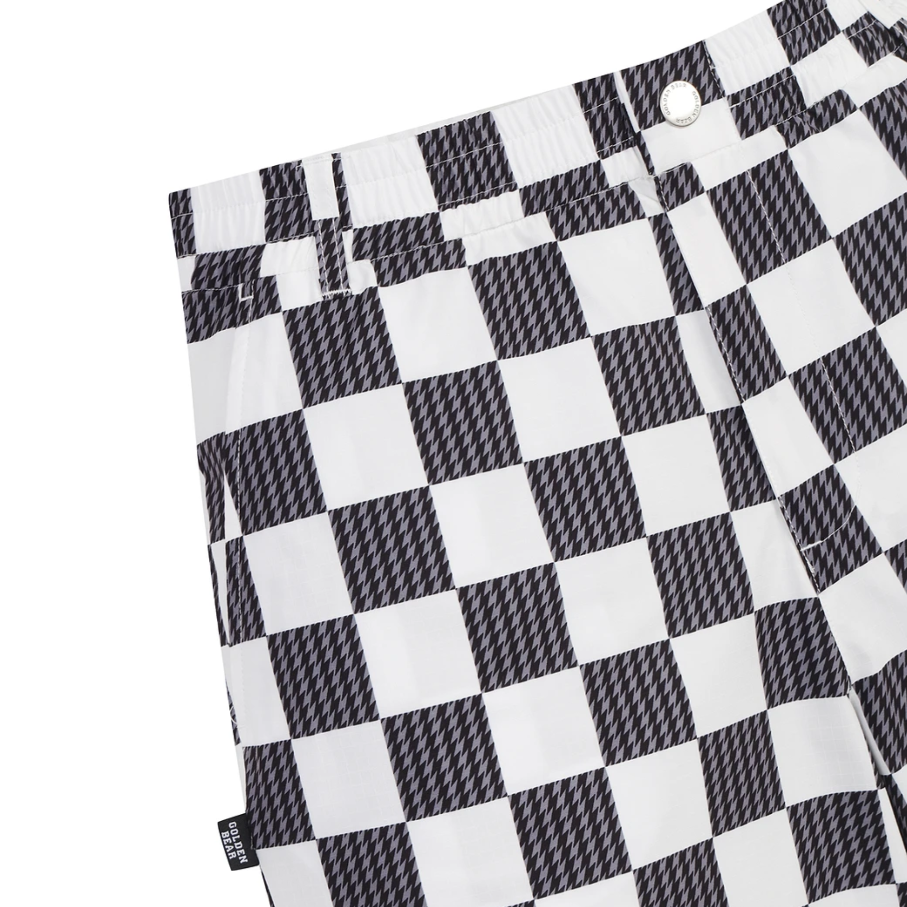 Close-up of a black and white checkerboard patterned garment, likely shorts or pants, showing the waistband, button, and fabric texture on a white background.