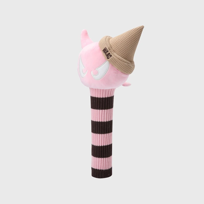A pink plush toy golf club headcover shaped like a cartoon character with a tan knit cone hat, shown on a light gray background.