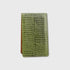 A slim, rectangular  yardage book holder featuring a textured green crocodile skin pattern, shown against a light gray background.
