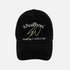 A black corduroy baseball cap featuring white and gold embroidered text on the front. The text reads &