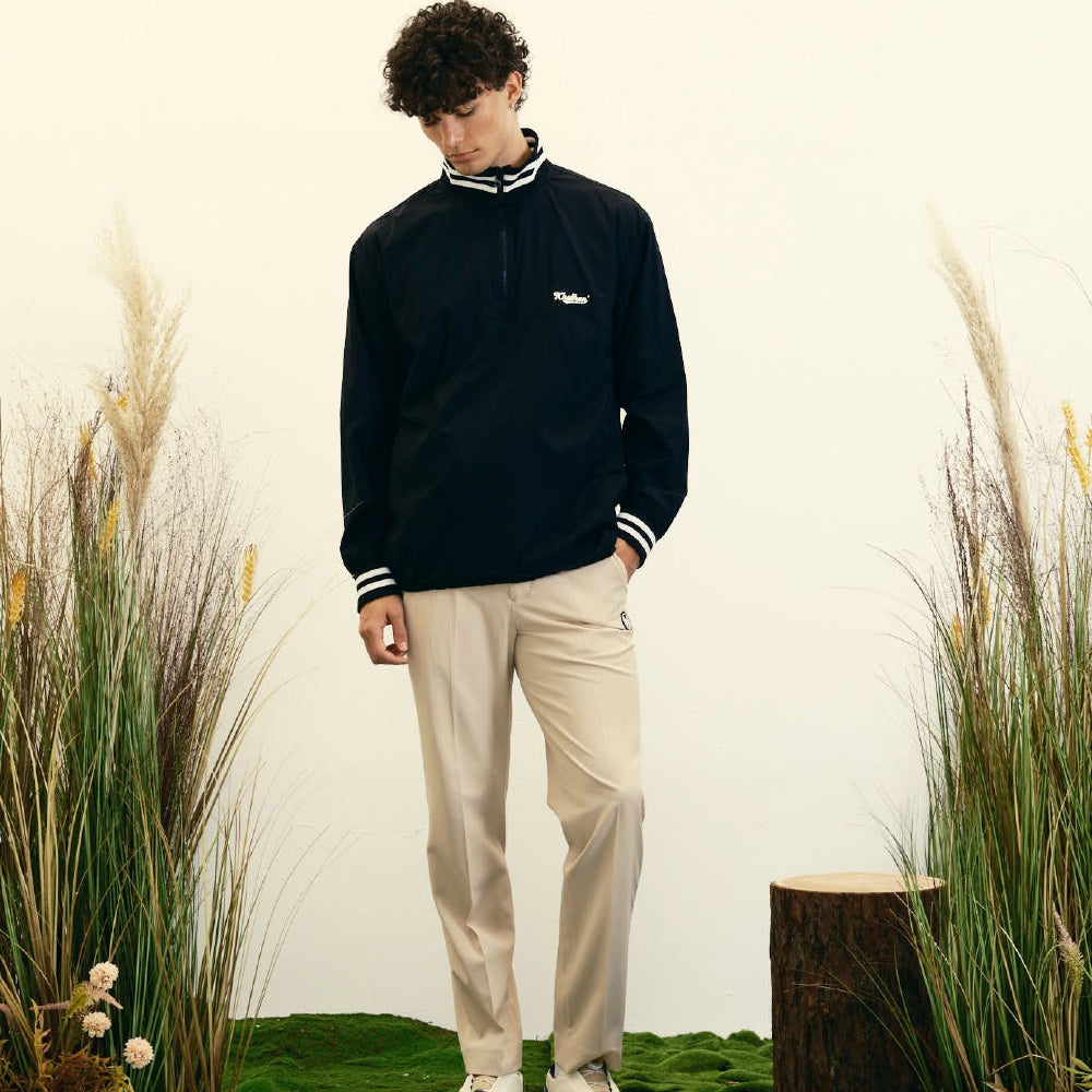 A three-panel collage showing a dark navy varsity-style jacket from different angles. The top panel shows a model wearing the jacket with beige pants in an indoor setting.