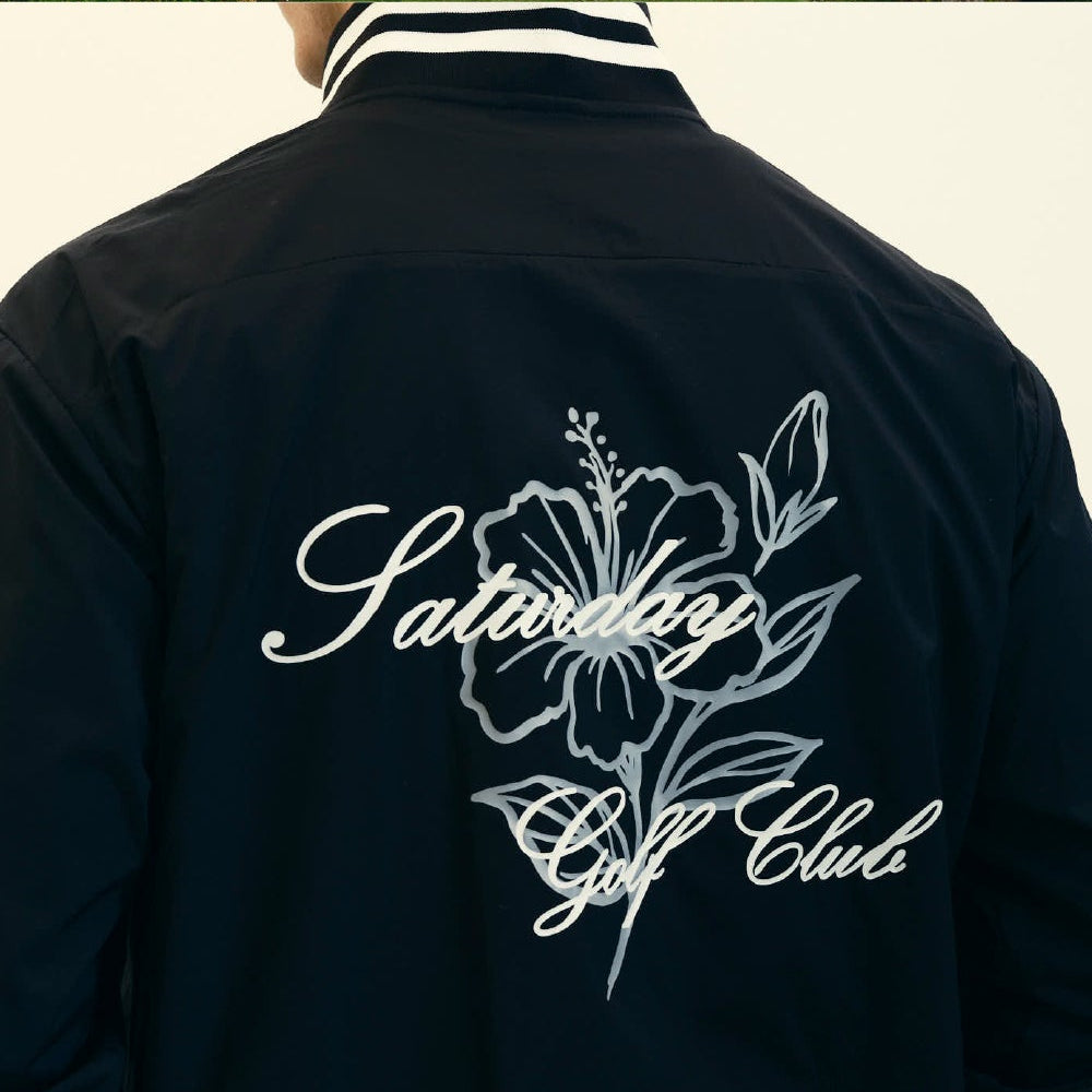 A three-panel collage showing a dark navy varsity-style jacket from different angles. The top panel shows a model wearing the jacket with beige pants in an indoor setting.