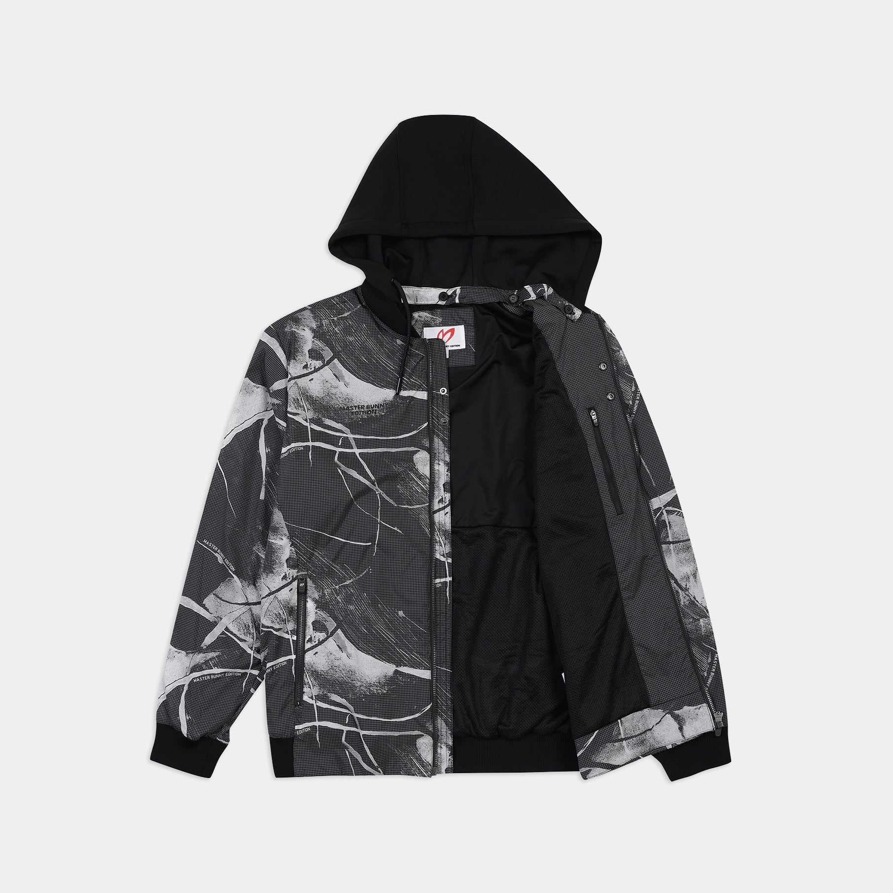 A black and white hooded jacket with a graphic marble pattern on the sleeves and sides, shown against a light gray background.