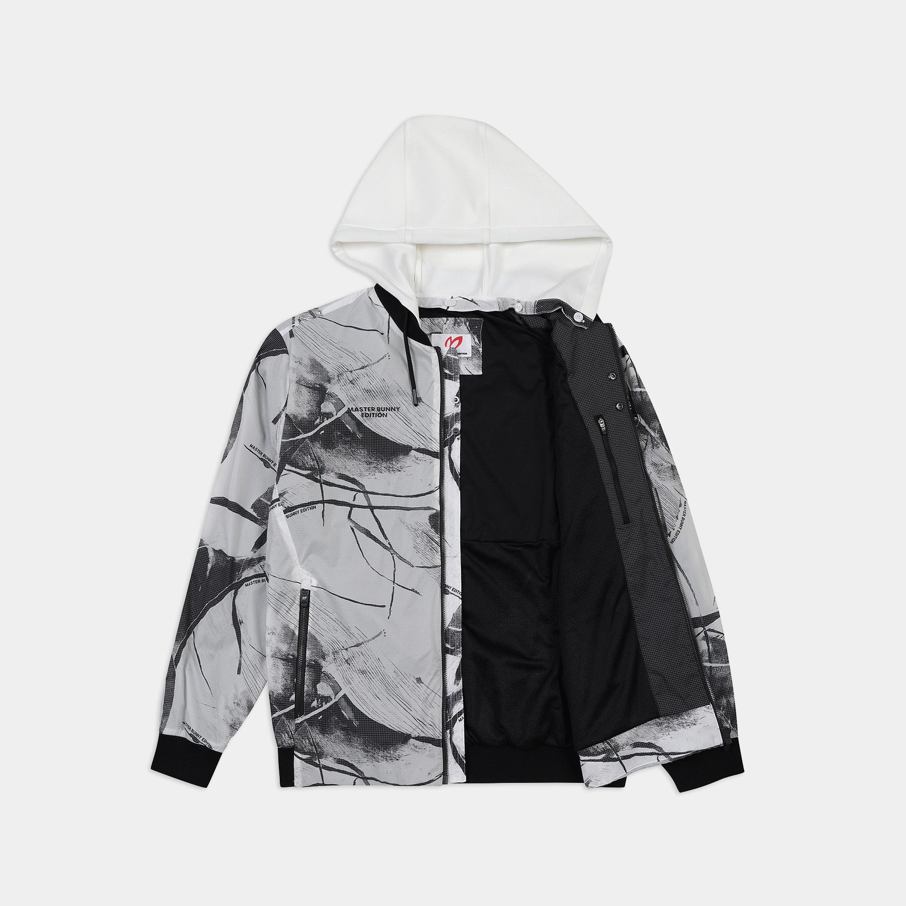 A hooded jacket with a black and white abstract brushstroke print on the outer shell, a solid black inner shell, and a white hood, shown against a light gray background.