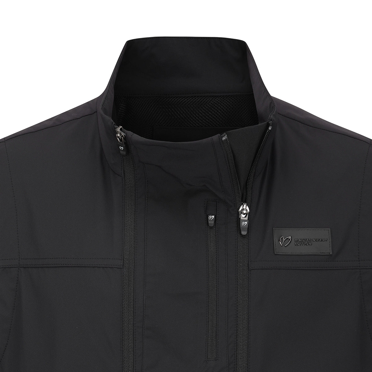 Close-up of a black softshell jacket with a stand-up collar, front zipper, and a small rectangular logo patch on the chest pocket. The brand name 'MASTER BUNNY EDITION' is visible on the patch.