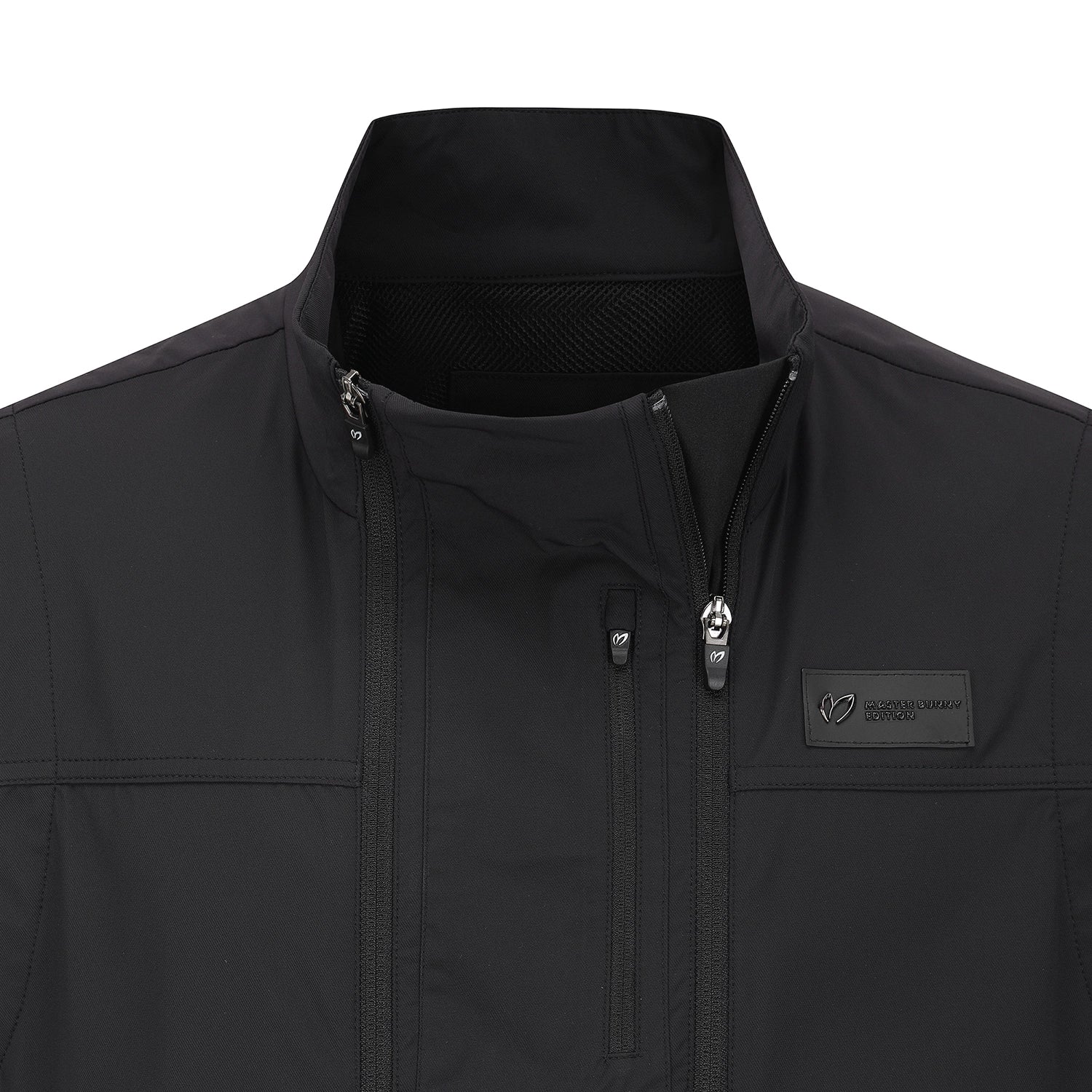 Close-up of a black softshell jacket with a stand-up collar, front zipper, and a small rectangular logo patch on the chest pocket. The brand name 'MASTER BUNNY EDITION' is visible on the patch.