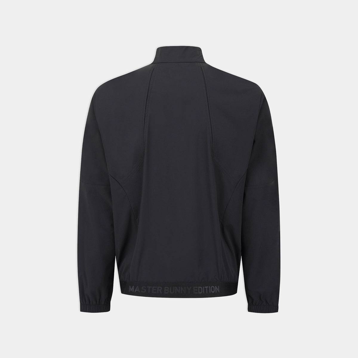 A black long-sleeve athletic jacket shown from the back, featuring a mock neck, zippered side pockets, and a black elastic hem with 'MASTER BUNNY EDITION' text, set against a light gray background.