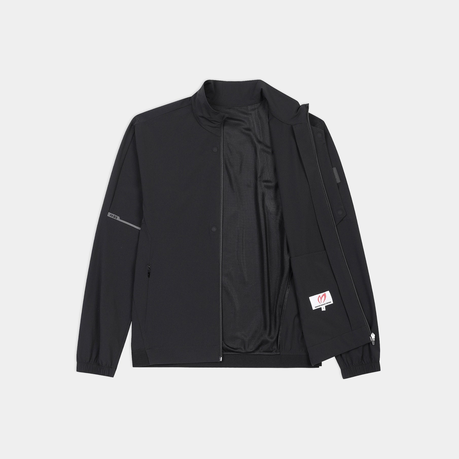 A black lightweight zip-up jacket with a stand collar, laid flat against a light gray background. The jacket features a black interior lining, a zippered sleeve pocket, and a small white brand patch on the left sleeve.