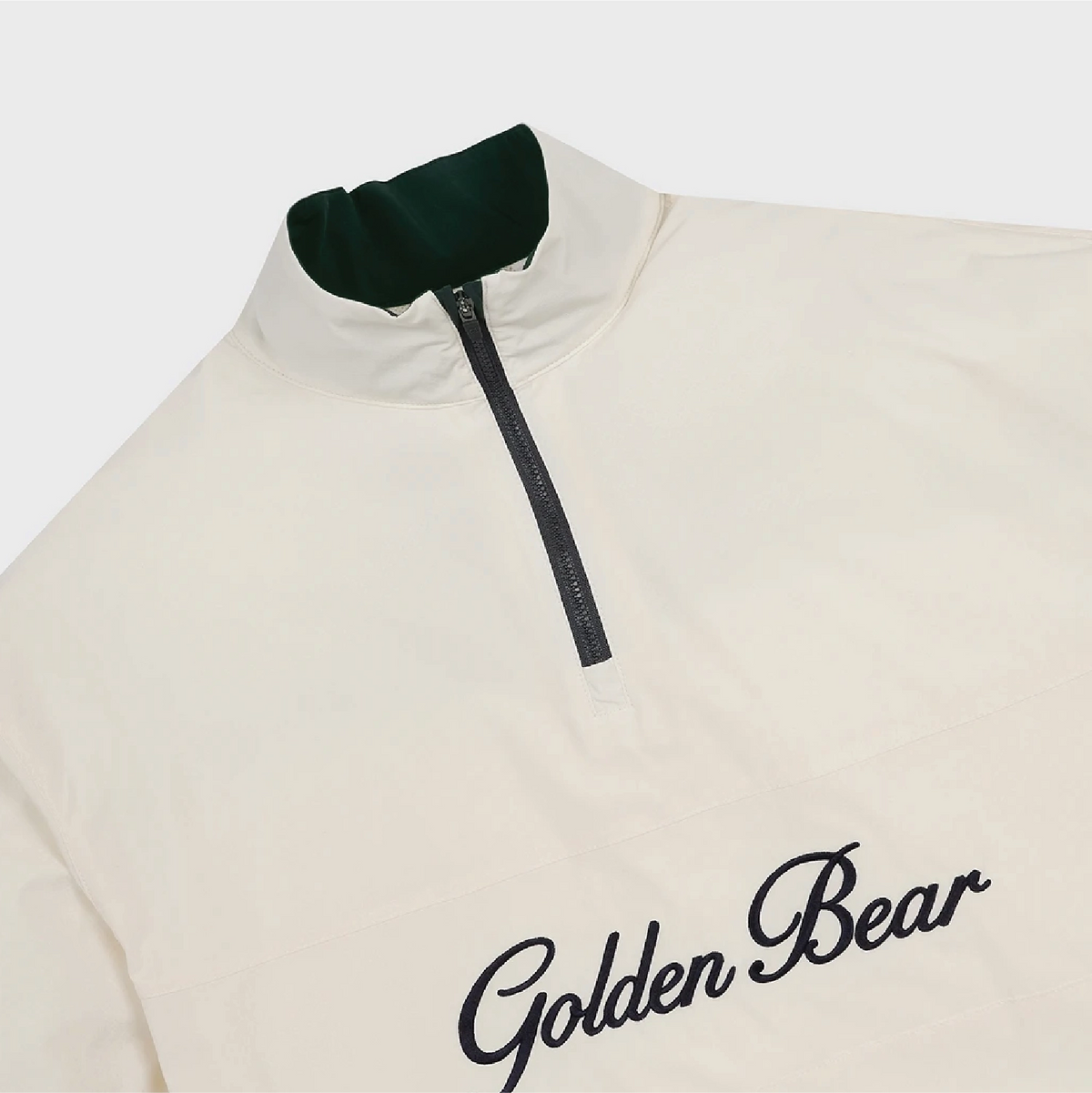An off-white quarter-zip pullover jacket with a dark green inner collar and black 'Golden Bear' script embroidery on the chest, shown against a light gray background.