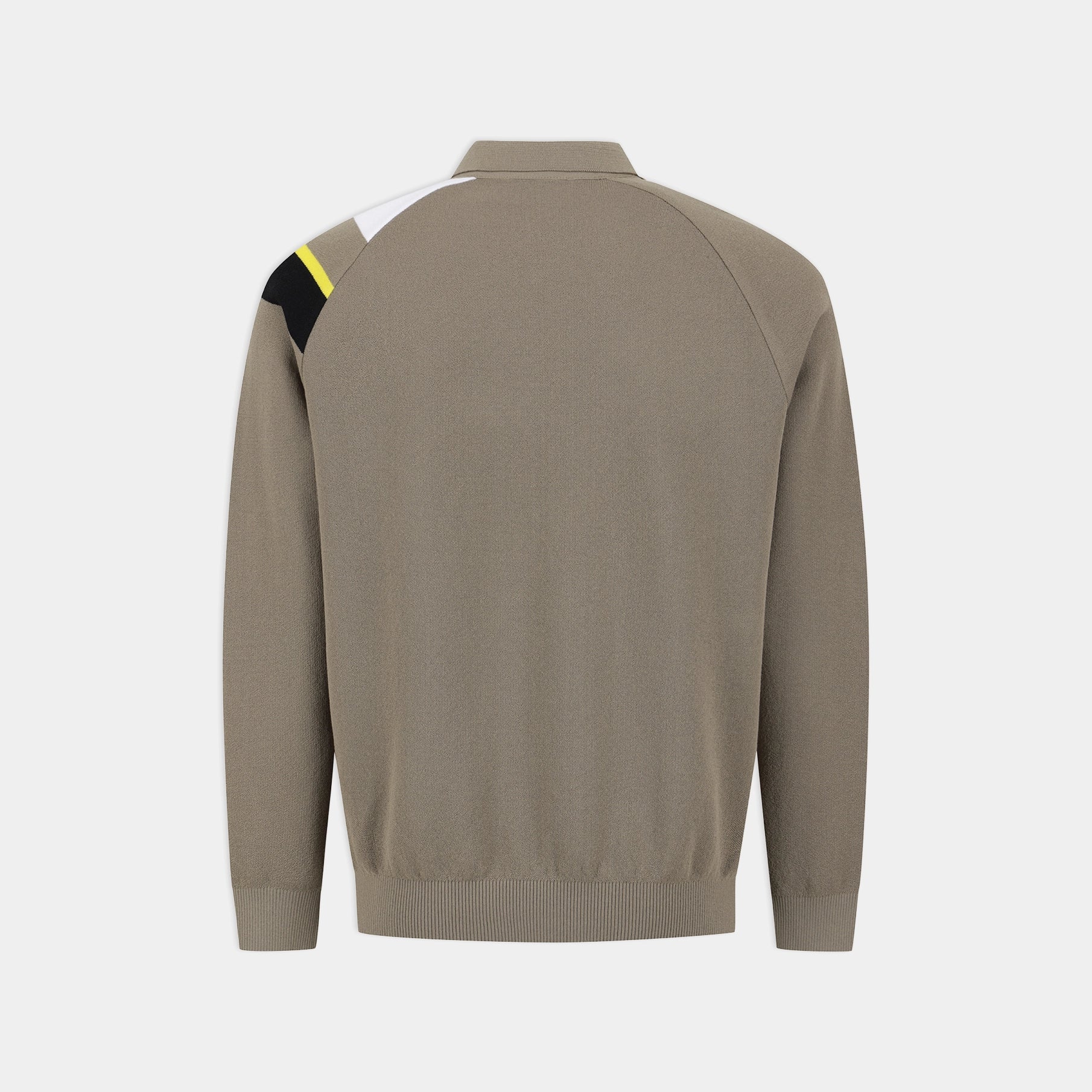 A taupe brown knit sweater shown from the back, featuring a color-blocked shoulder design with black, white, and a small yellow accent on a light gray background.