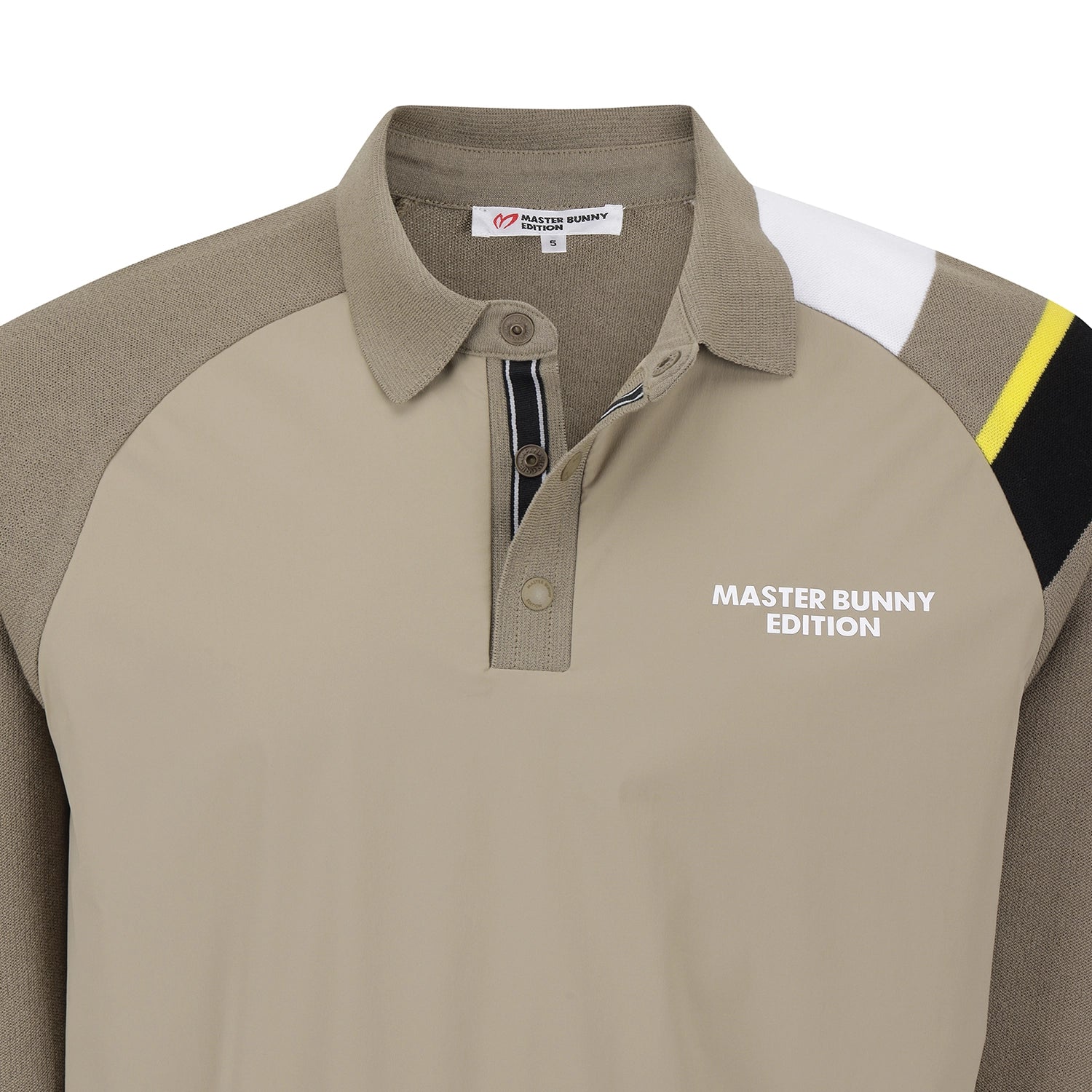 A close-up of a colorblock polo shirt with a beige body, taupe sleeves and collar, white shoulder panels, and a yellow stripe accent. The shirt features 'MASTER BUNNY EDITION' printed in white on the left chest.