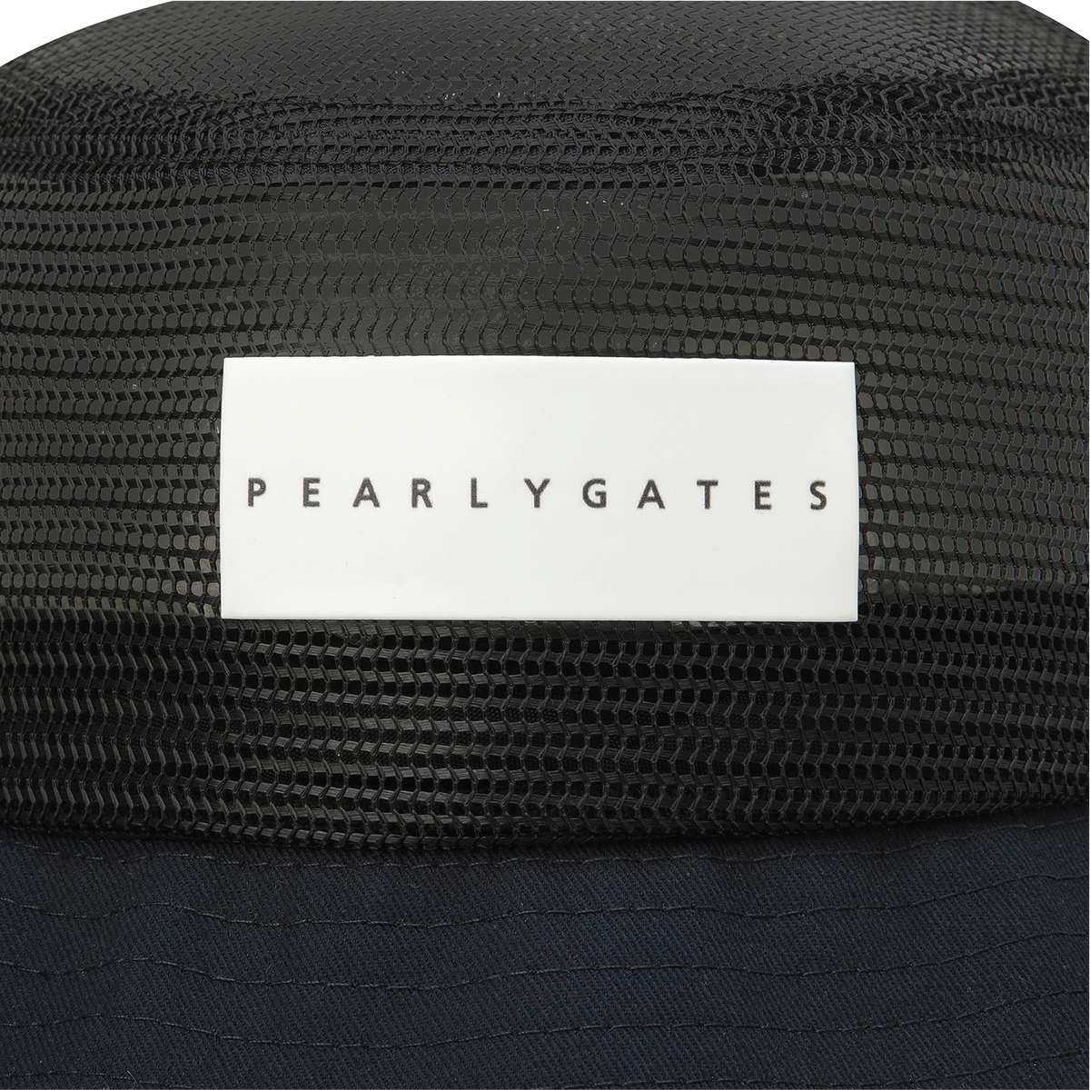 Close-up of a black mesh trucker hat with a white rectangular patch on the front displaying the brand name 'PEARLYGATES' in black text.
