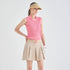 A woman modeling a pink sleeveless collared button-front top with beige pleated shorts, a beige visor, and a white glove against a light gray studio background.