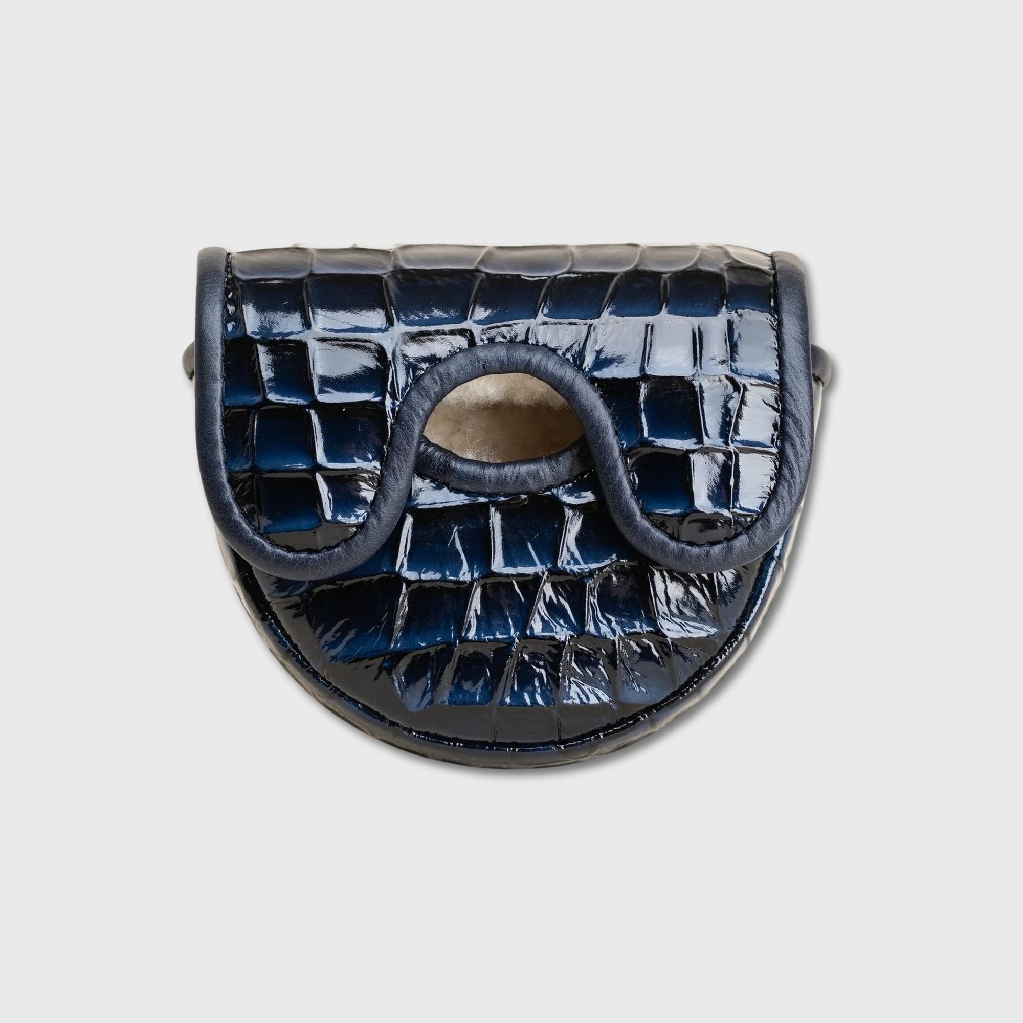 A glossy crocodile-embossed leather OZ1 putter cover in dark navy blue, featuring a distinctive wavy cutout detail on the front flap, set against a solid light gray background.