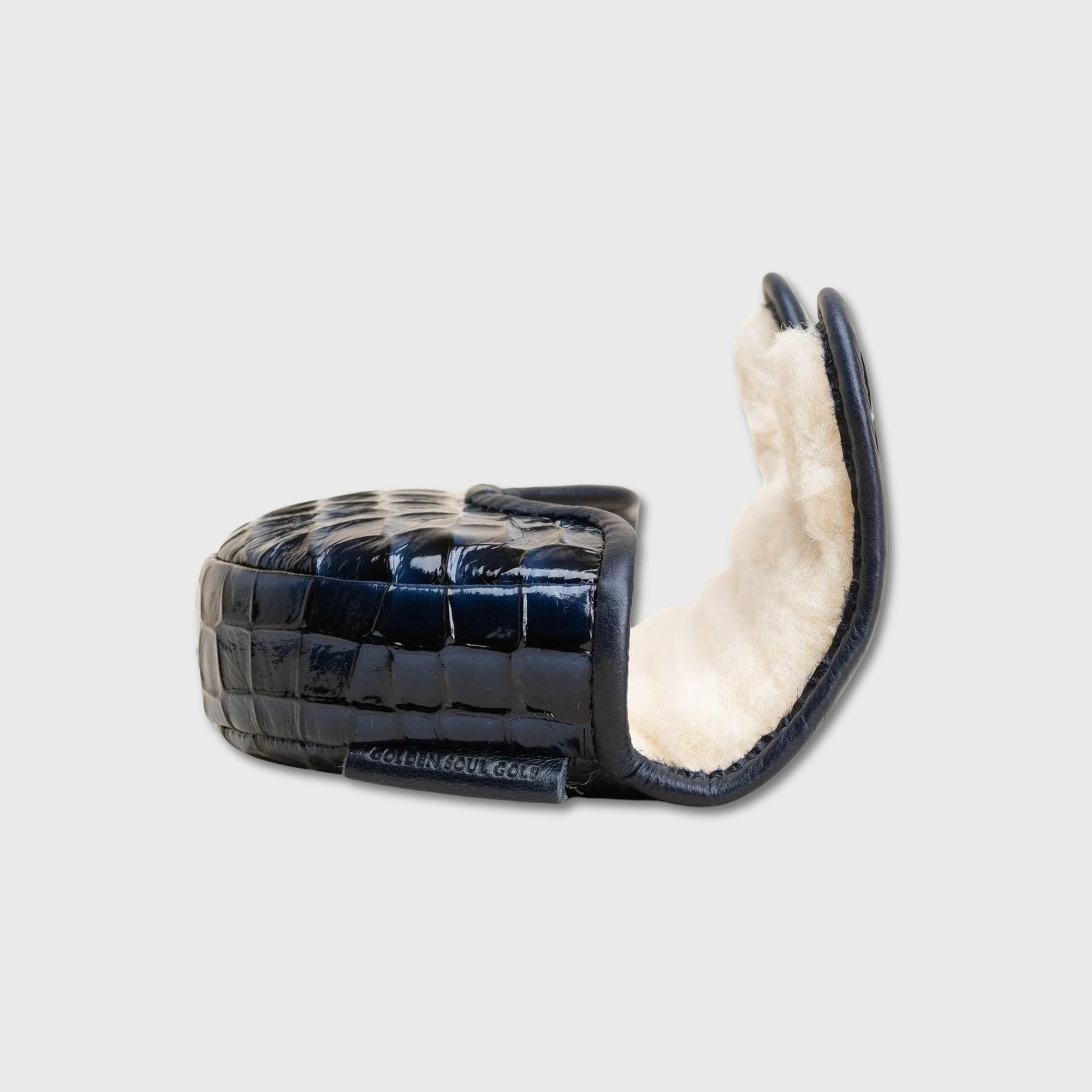 A single black crocodile-embossed OZ1 putter cover with a soft cream shearling lining, shown open against a light gray background.