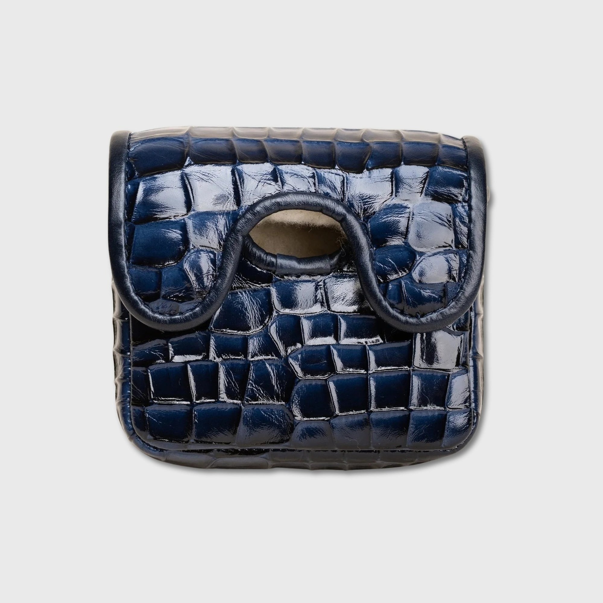 A small navy blue crocodile-embossed leather ZT Spider putter cover with a curved top handle and a circular cutout, shown against a light gray background.