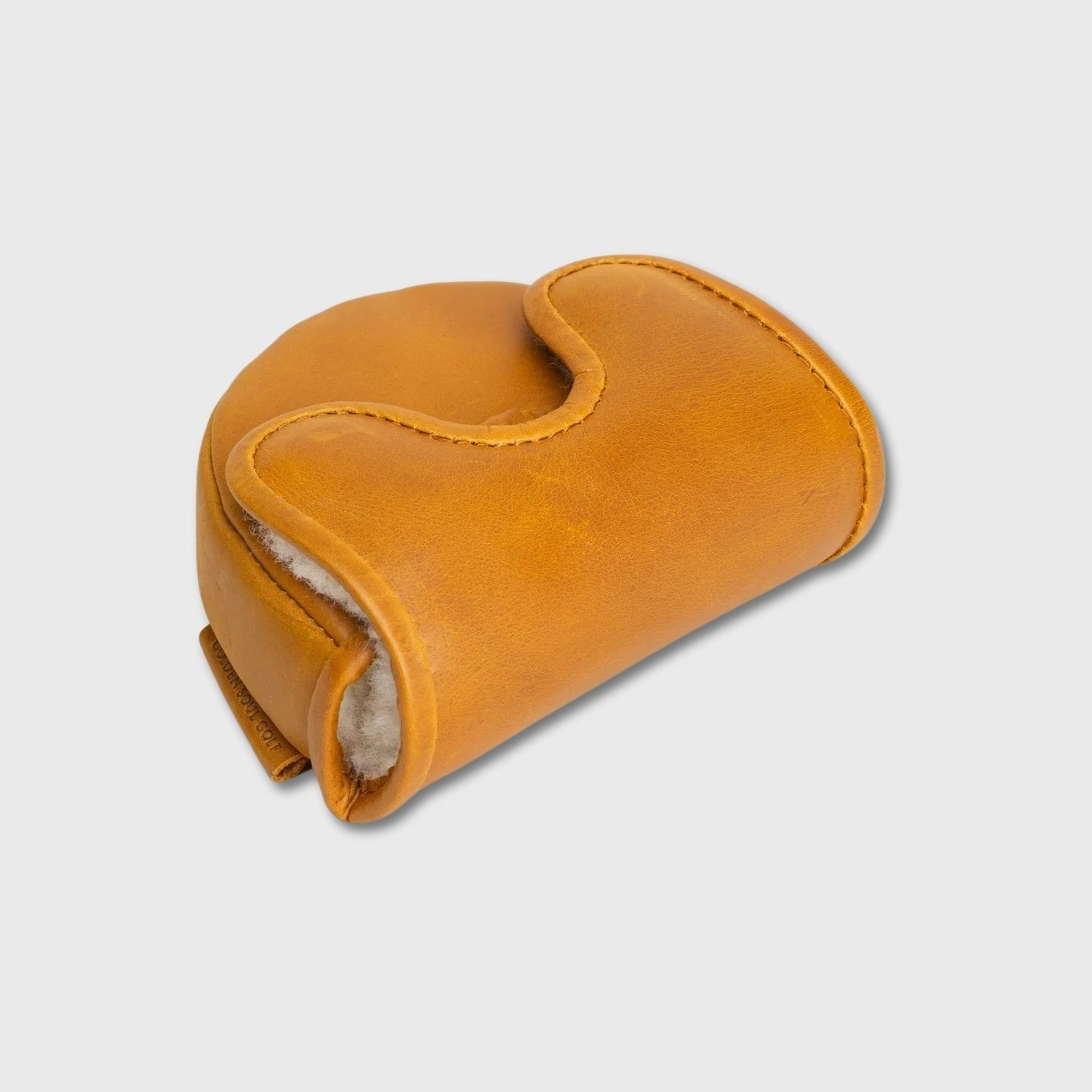 A tan leather OZ1 Putter Cover with a curved, ergonomic shape and a soft white fleece lining, shown on a light gray background.