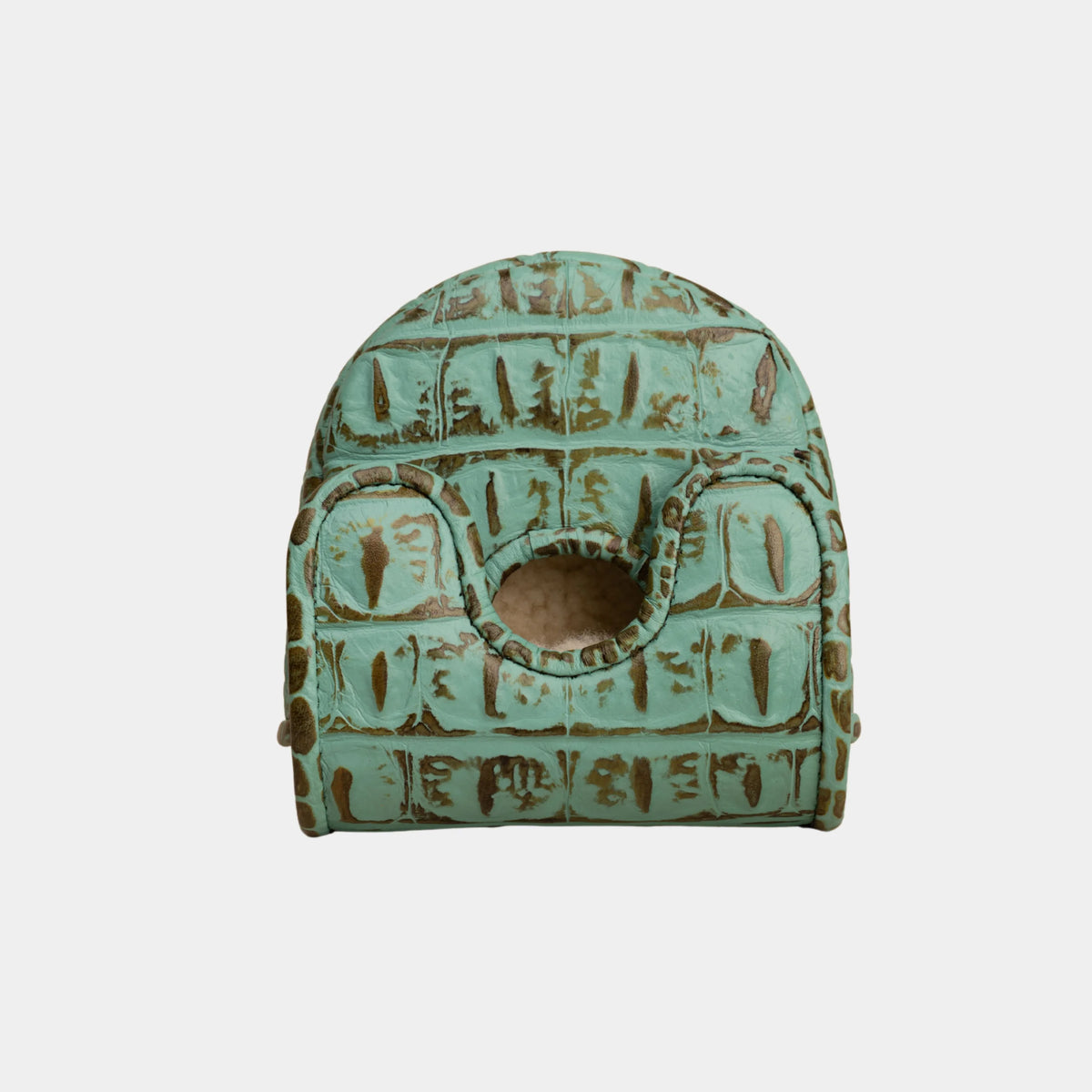 A small vintage-style green crocodile-patterned center df3 putter cover with a circular cutout, shown against a plain light gray background.