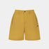 A pair of mustard yellow shorts with black zipper details on the sides and a small black &